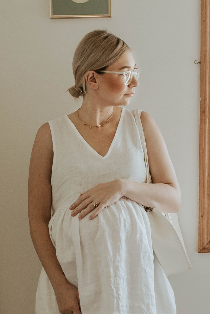 white linen dress, white sandals, white circle bag, linen maternity dress