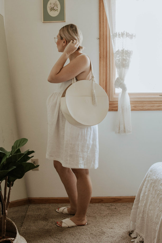 white linen dress, white sandals, white circle bag, linen maternity dress