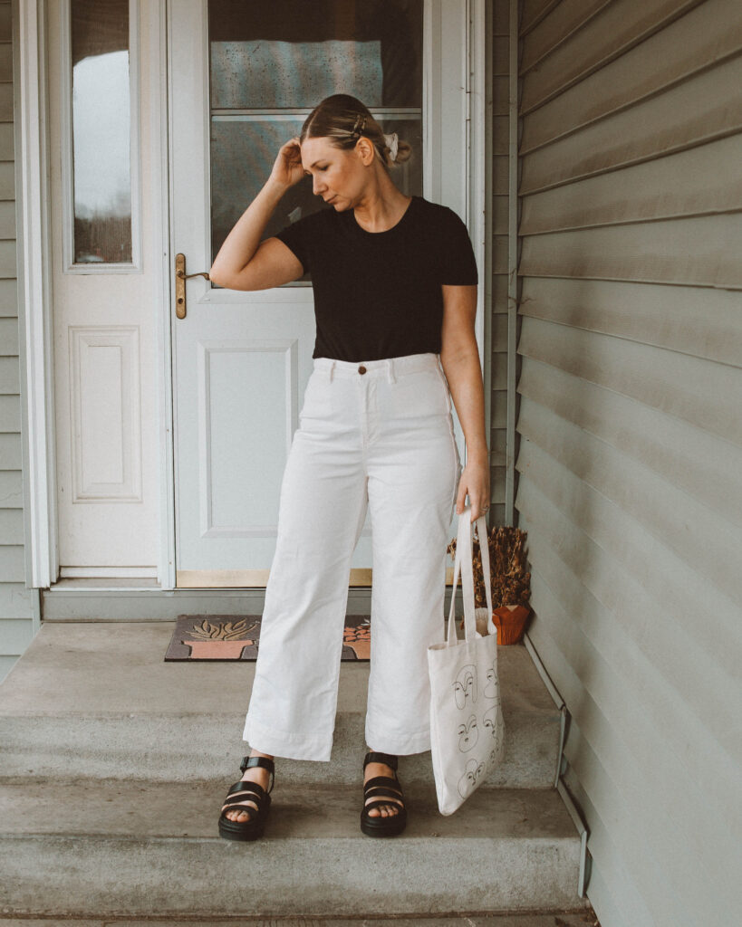 So here's what I actually wore this week, black tee, organic basics, white wide leg pants, gap pants, tradlands tote, dr. marten blaire sandals