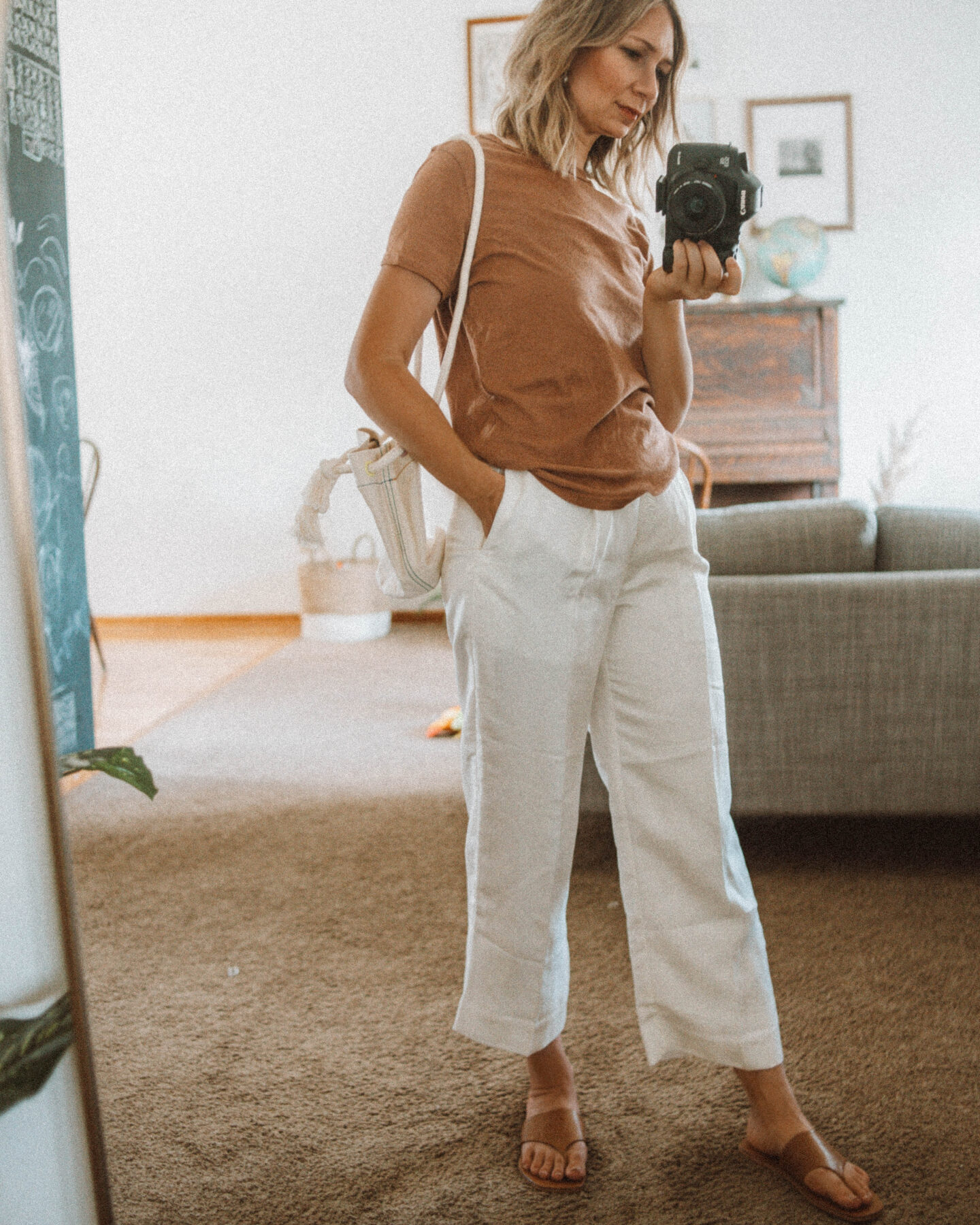 A Week of Outfits: Casual, Stylish Outfits for Real Life. caramel colored tee, madewell canvas bag, j. crew pleat white pants, everlane thong sandals, pyne & smith model no. 26