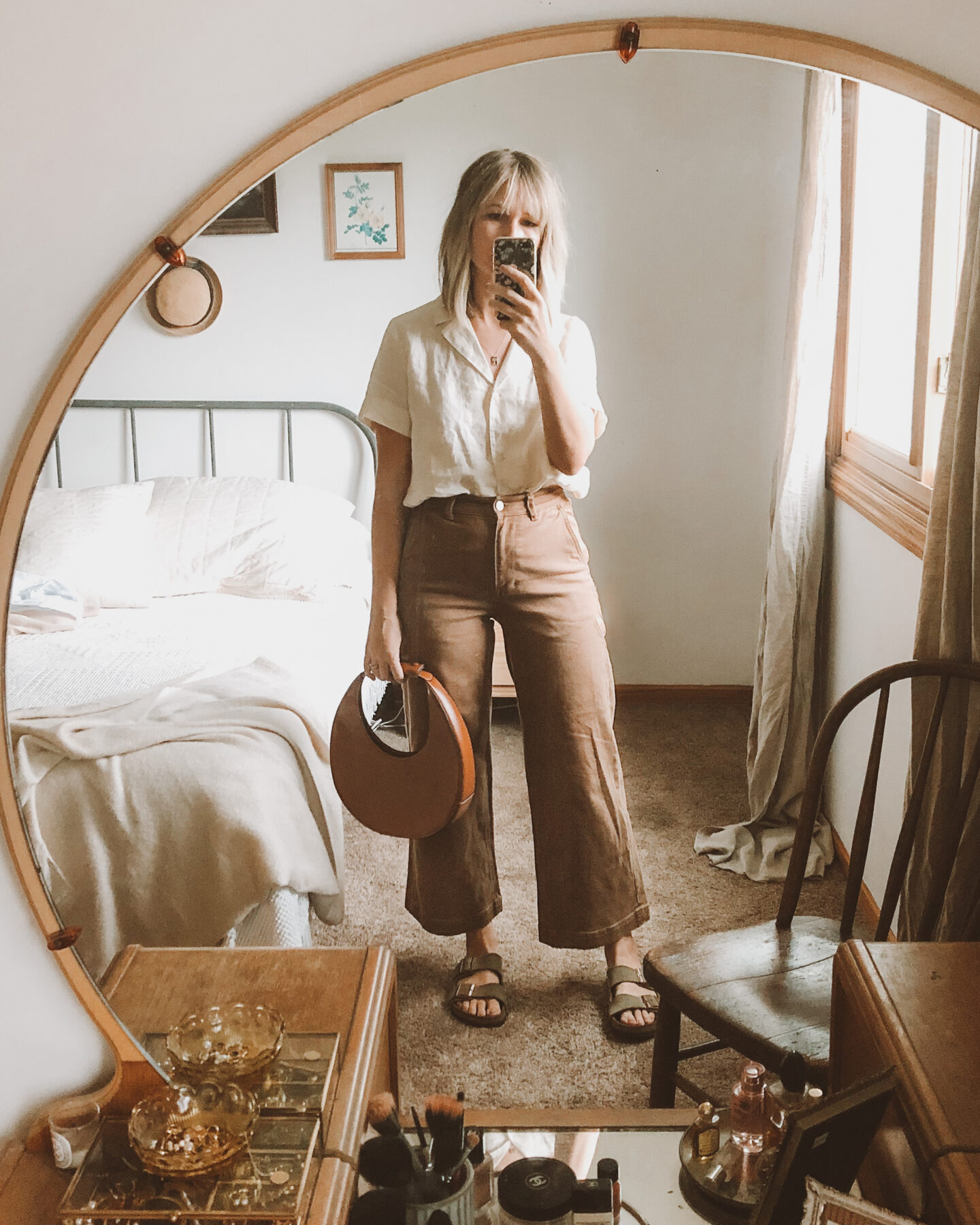 Fall Transitional Dressing: Everlane short sleeve linen notch shirt paired with their wide leg pants in ochre and the staud moon bag with birkenstock arizonas