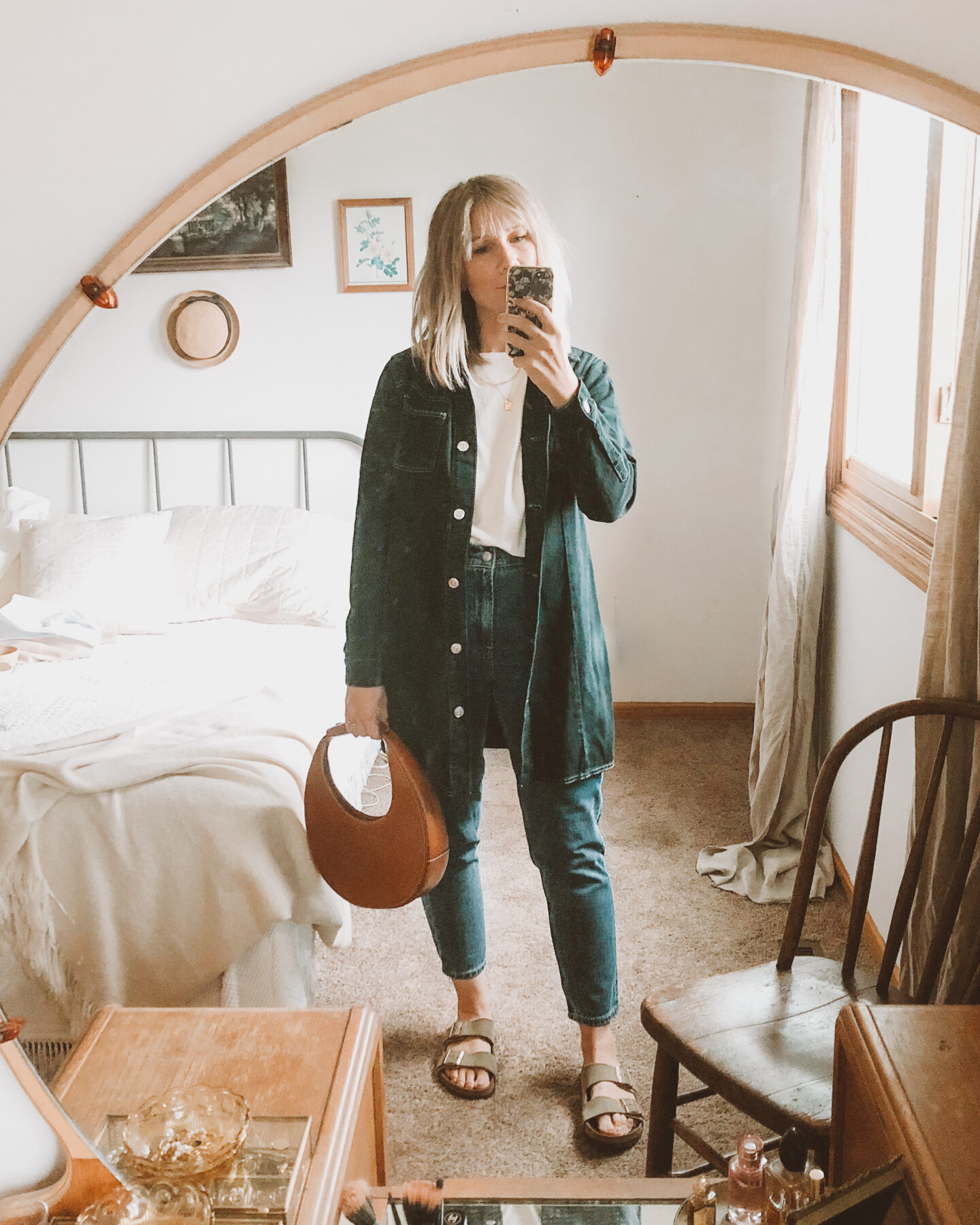 Fall Transitional Dressing: all denim outfit with mom jeans, sweater tee and chore jacket paired with birkenstock arizonas and the staud moon bag which is a circle bag