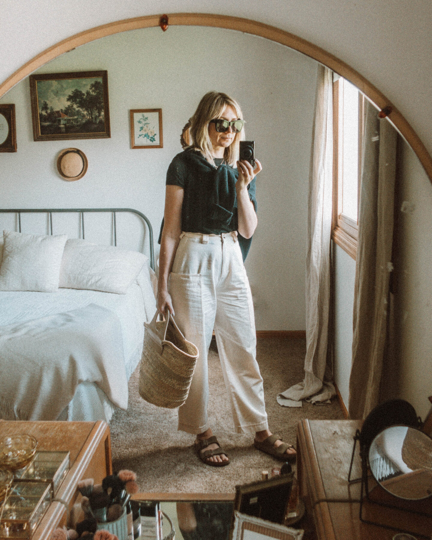 What I Wore this Week: From Tank Tops to Trench Coats, wide leg cargo pants, black tee, black sweater, birkenstock arizona, hereu straw bag, sweater over the shoulders