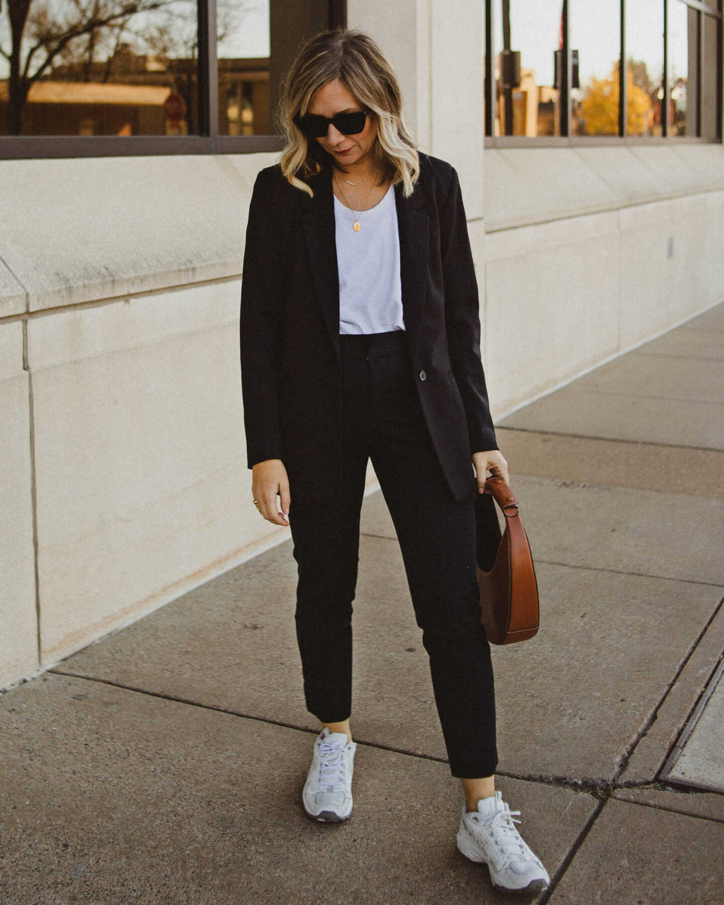 power suit, black boyfriend blazer, black skinny work pants, new balance sneakers, staud moon bag