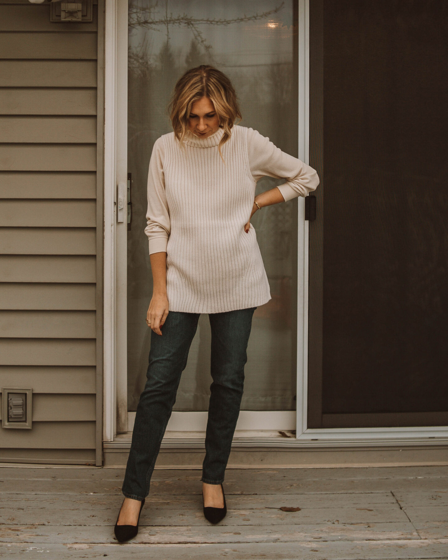 cozy at home christmas outfit ideas, sweater vest, straight leg jeans, black kitten heels