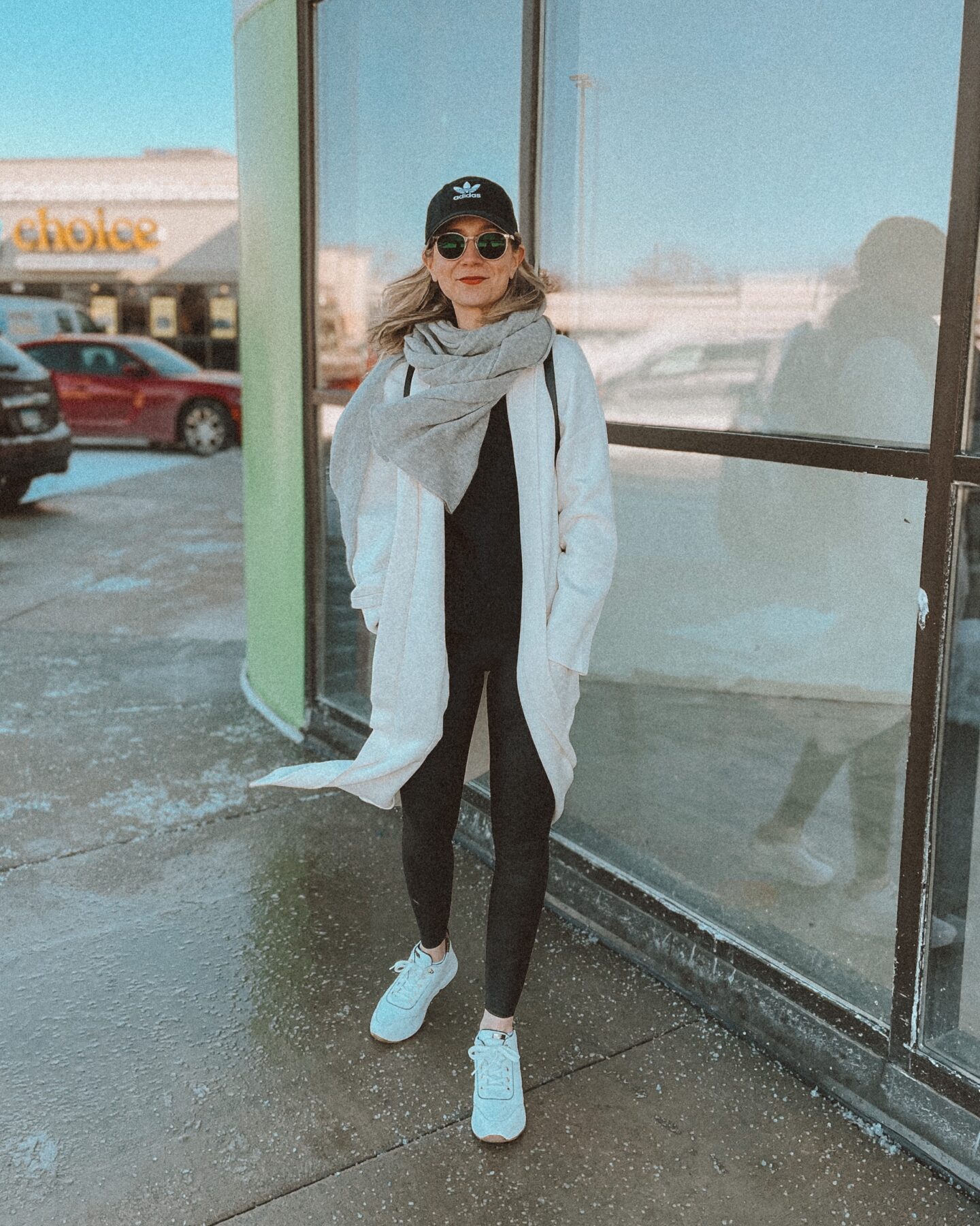 leather leggings, white duster cardigan, white sneakers, black baseball cap