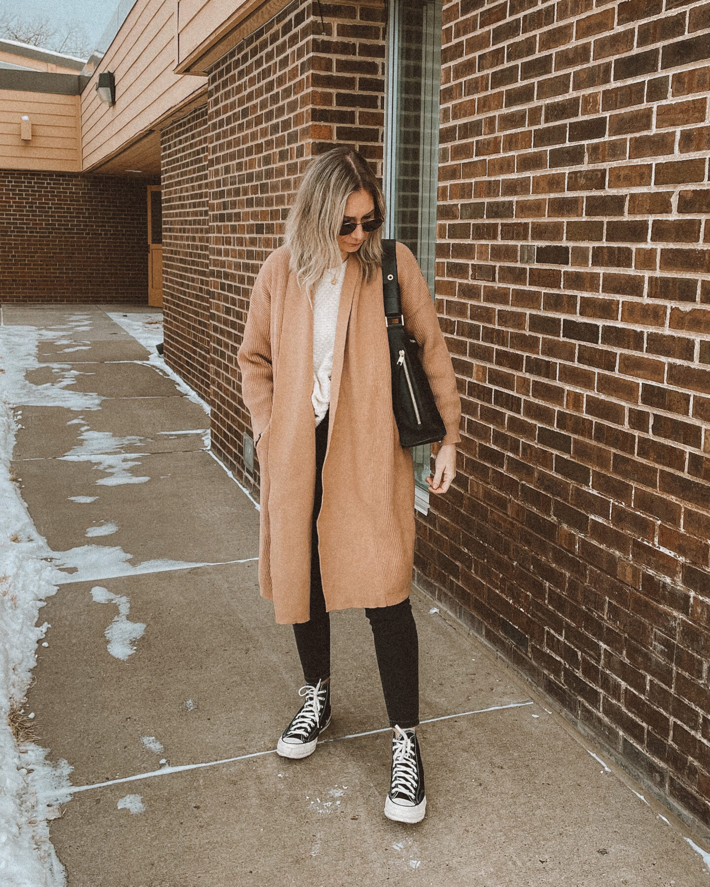 cream sweater, black leather back pack, gray skinny jeans, cream sweater, gray skinny jeans, black high top converse