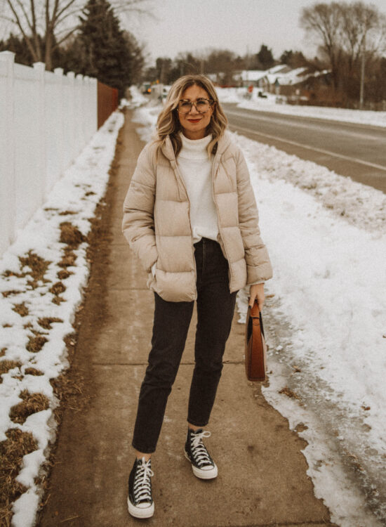 cream puffer coat, white turtleneck sweater, washed black jeans, black high top converse, staud moon bag