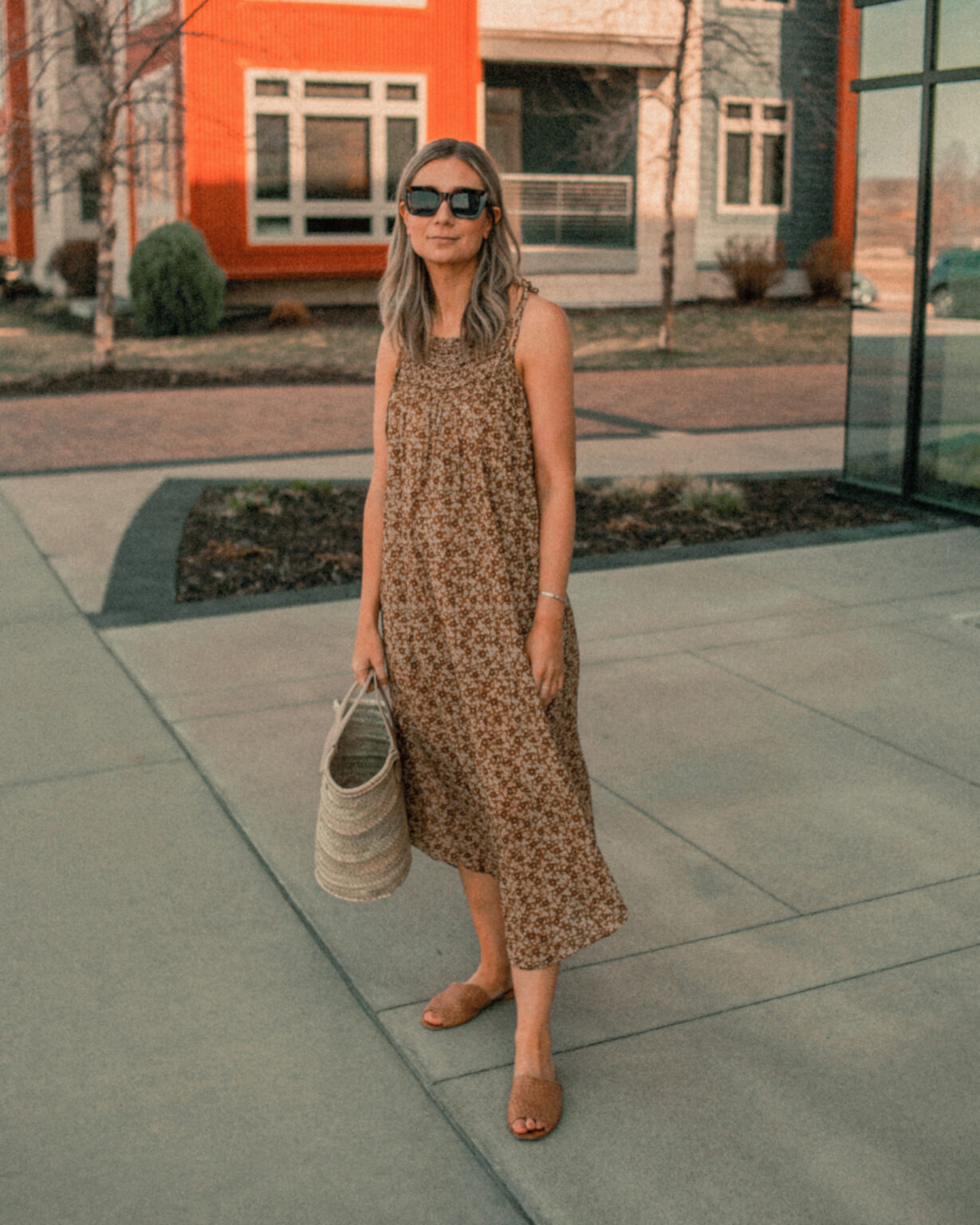 Floral print summer dress, woven sandals, and a basket bag