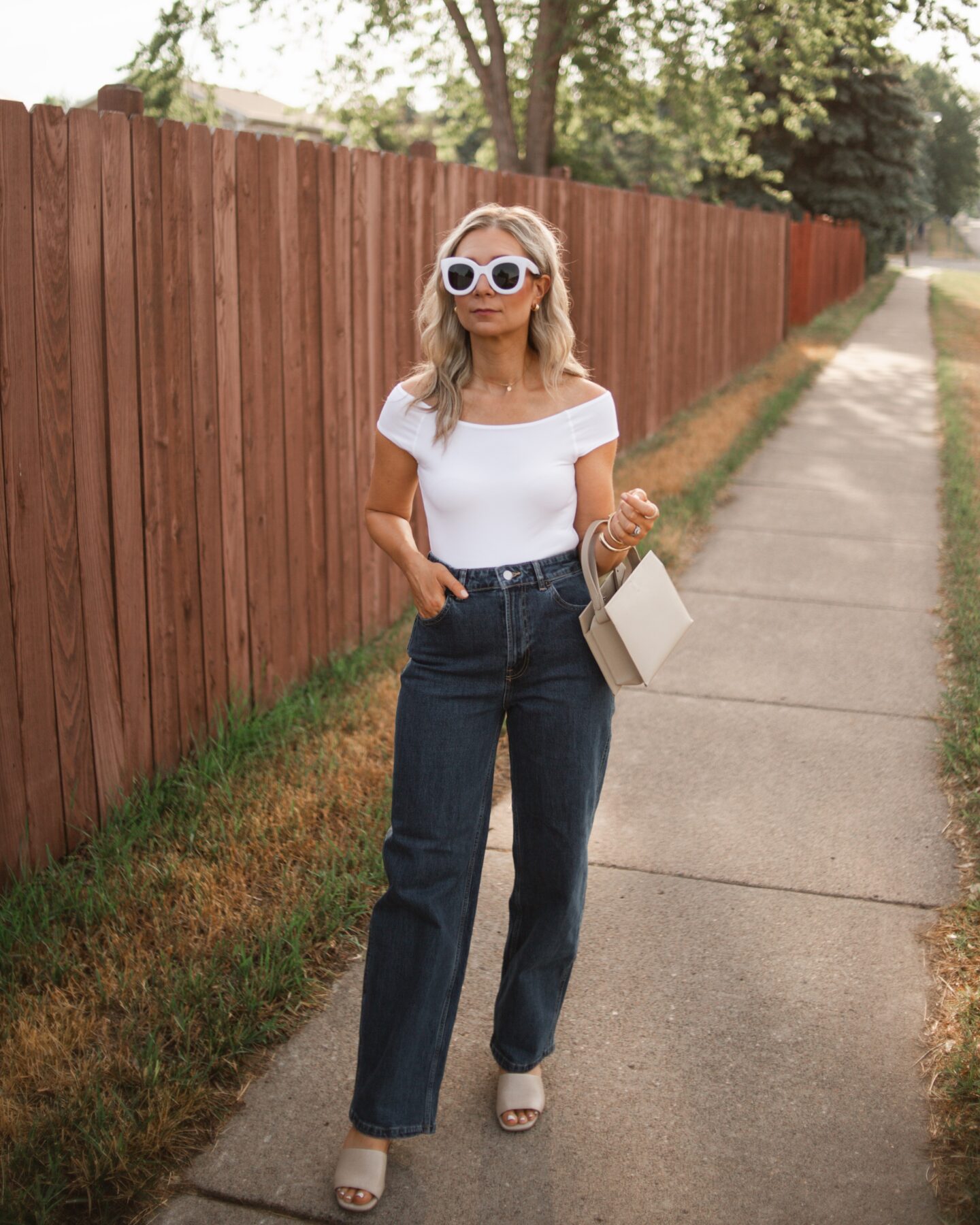 Karin Emily wears the Everlane Way High Baggy Jean, white bodysuit, nude sandals heels for her Everlane Denim Guide