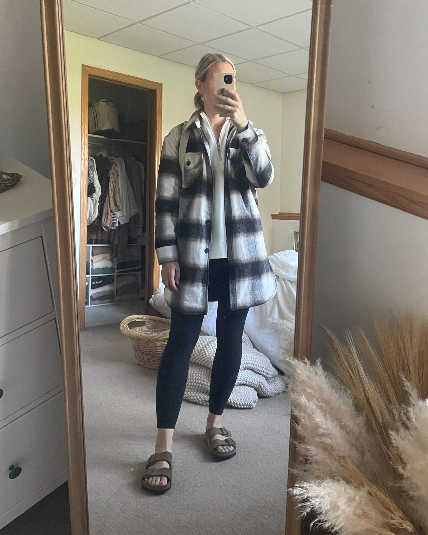 Karin Emily wears a plaid shacket, lululemon align leggings, and birkenstock arizona sandals, and a white half zip sweatshirt 