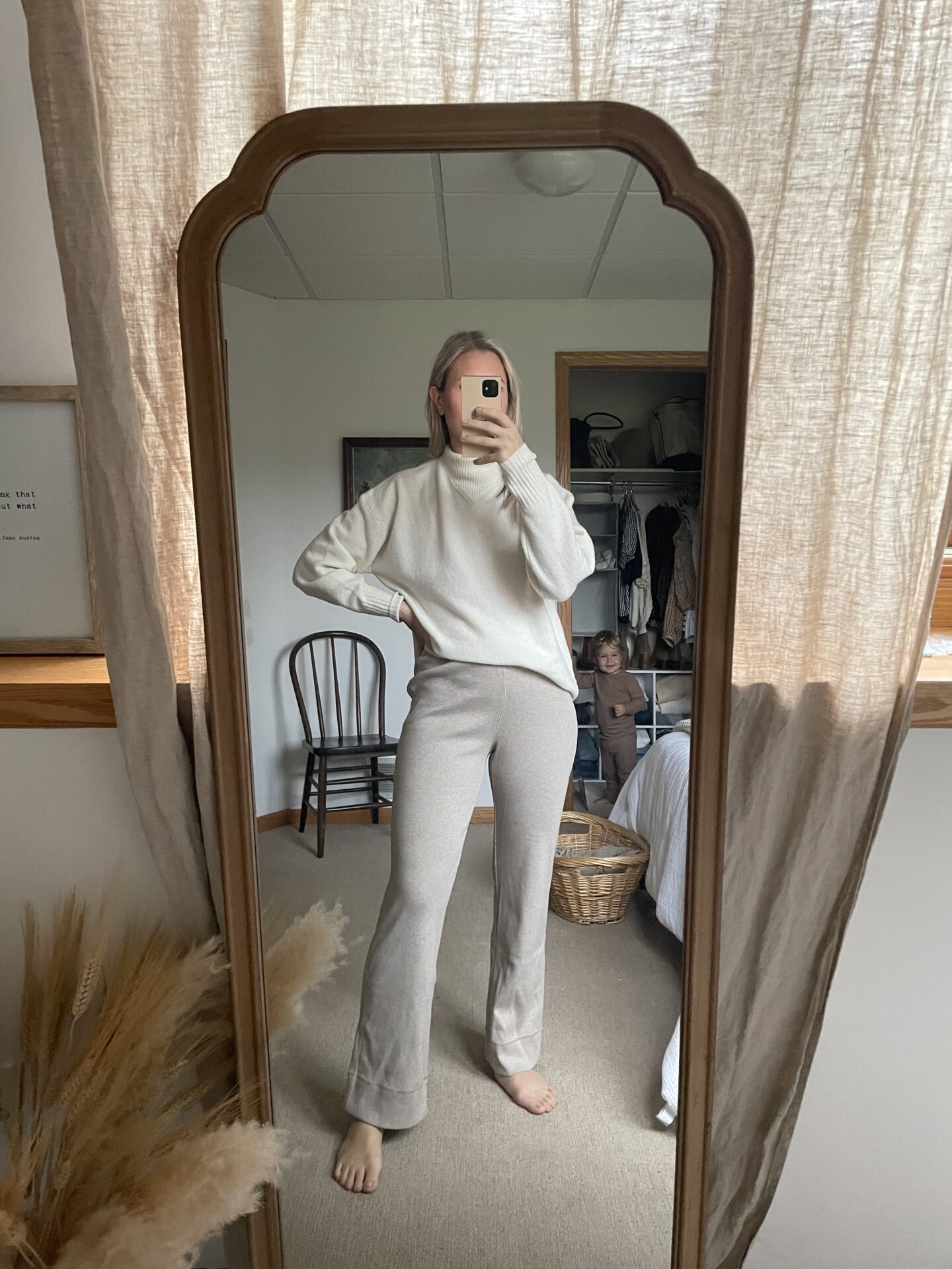 Karin Emily wears an oversized ivory sweater, and a pair of ribbed lounge pants - everlane for fall