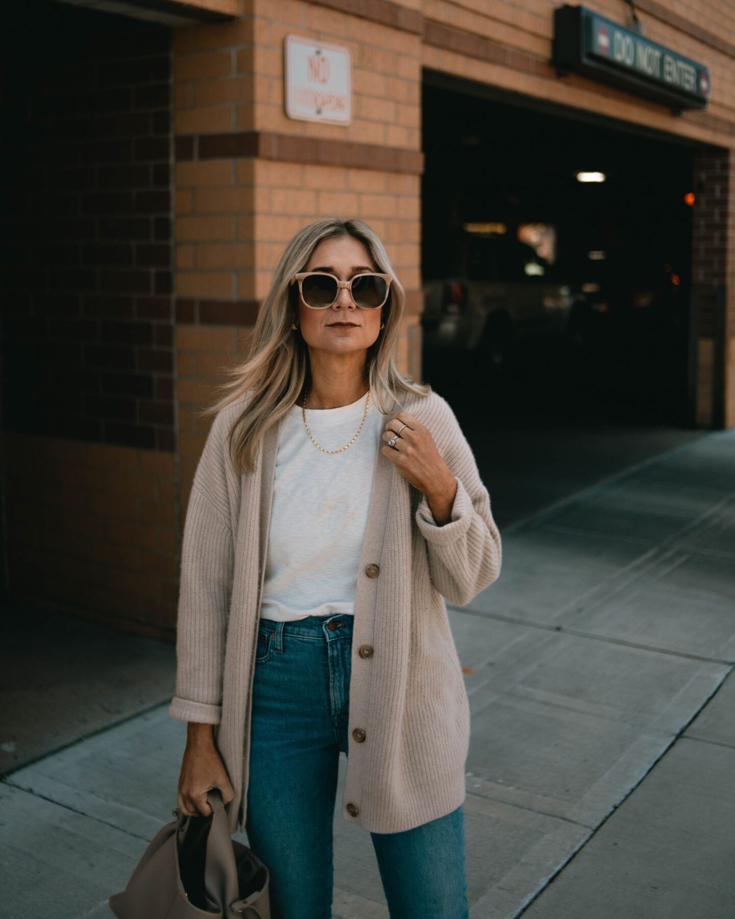karin emily wearing the jenni kayne cozy sweater for fall with a cream tee and madewell perfect vintage jeans and a pair of clear sunglasses
