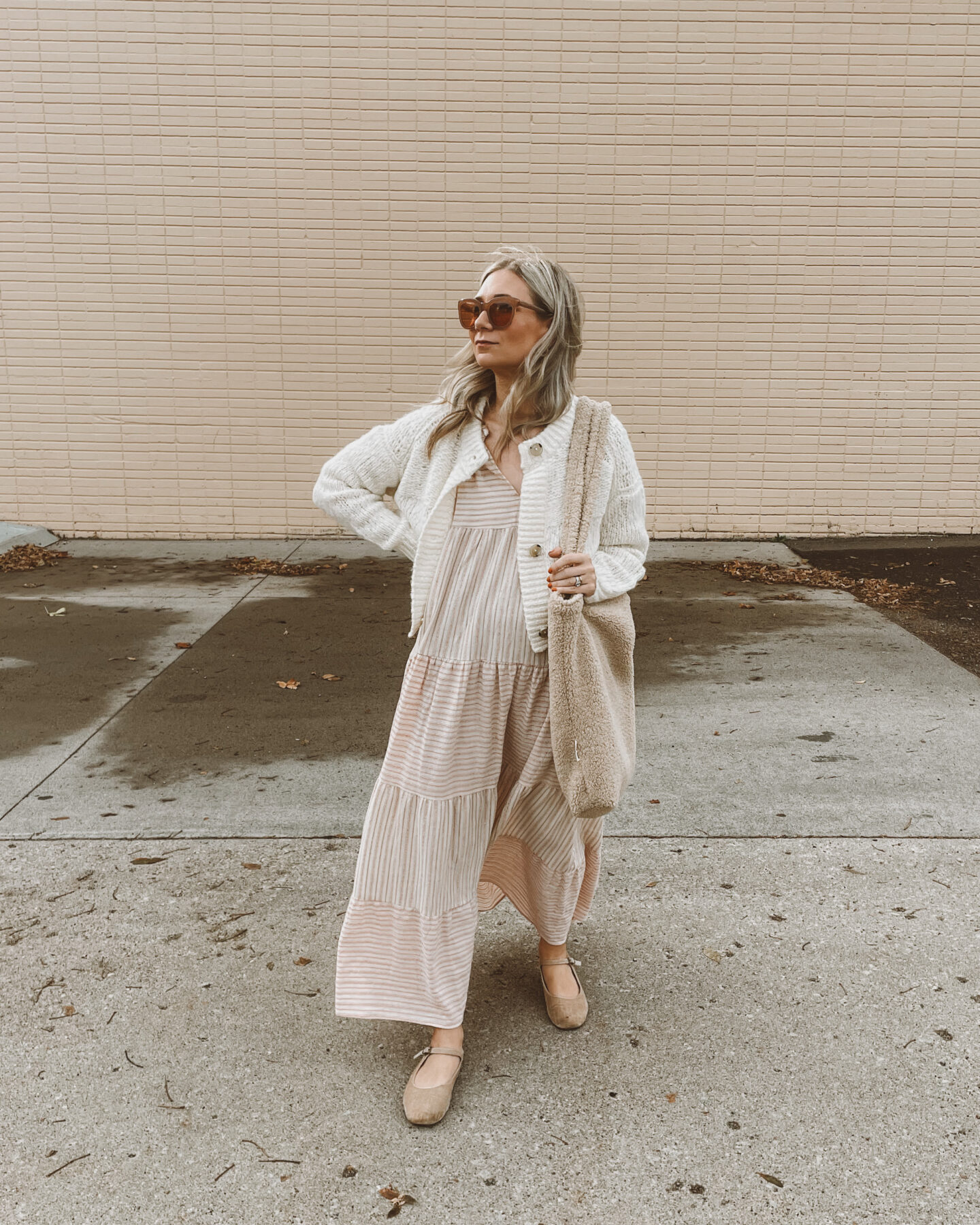 Karin Emily wears a fall maxi dress with an everlane cropped cardigan, velvet Mary Jane's, oversized sunglasses and a sherpa bag