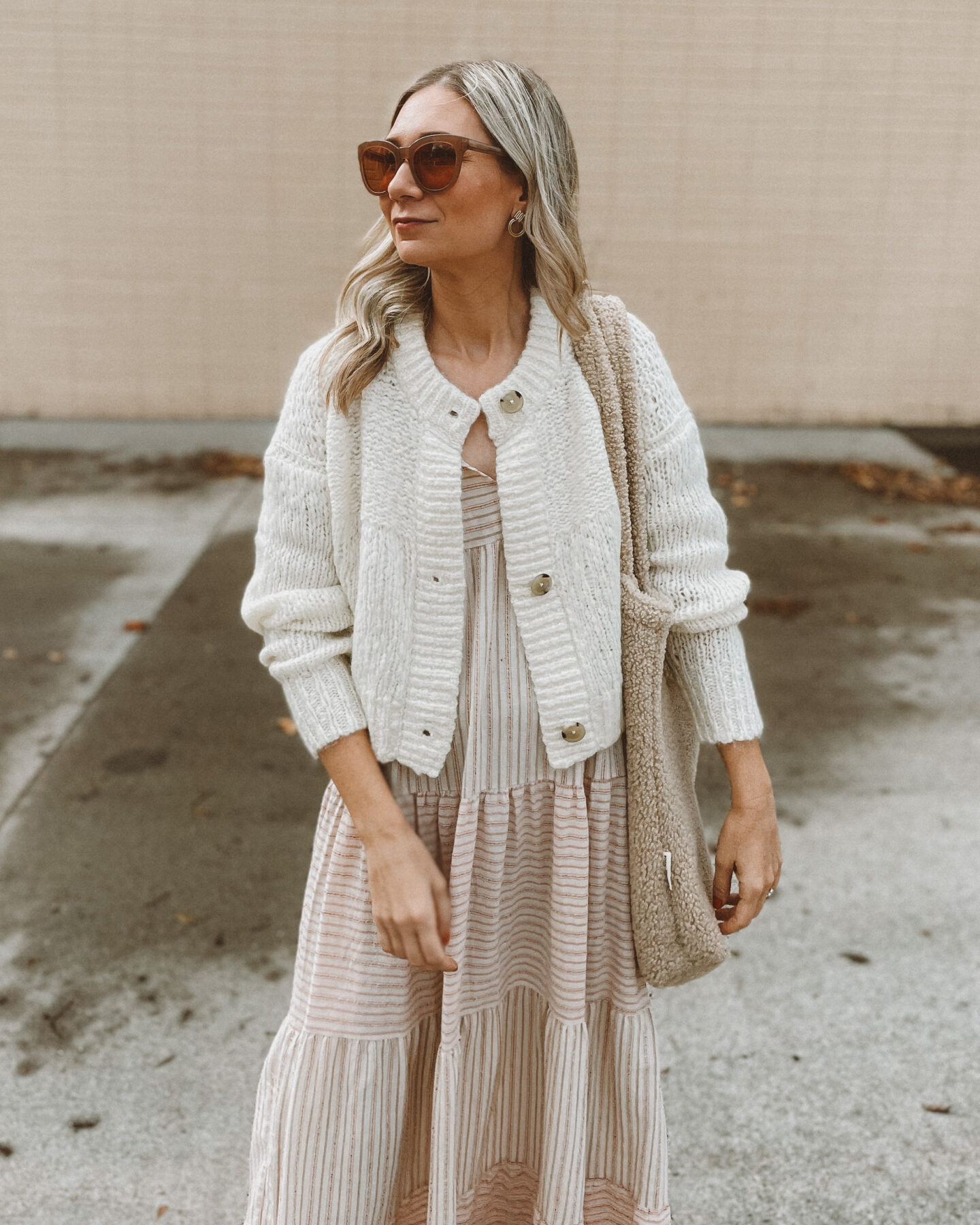 Karin Emily wears a fall maxi dress with an everlane cropped cardigan, velvet Mary Jane's, oversized sunglasses and a sherpa bag