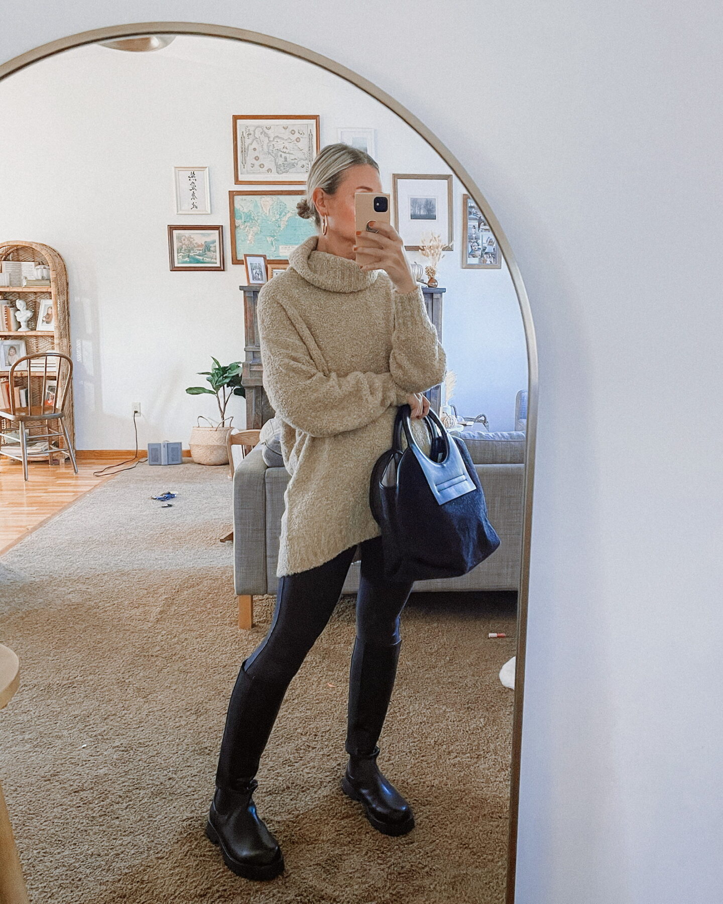 Karin Emily shares Thanksgiving outfit ideas with a boucle turtleneck sweater, faux leather leggings, and black knee high lug boots