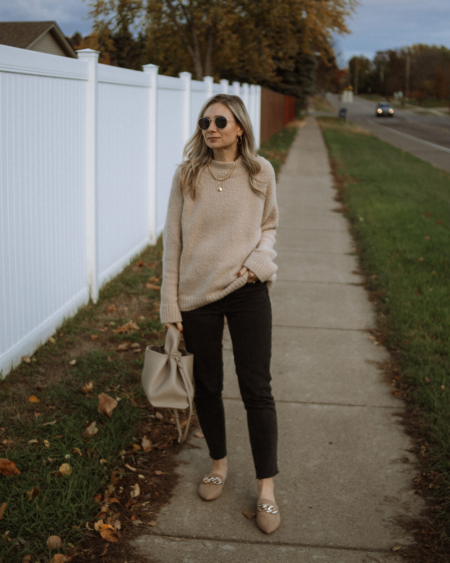 Karin Emily shares Thanksgiving Outfit Ideas and wears an oversized sweater from the Nordstrom Anniversary Sale, Washed Black Perfect Vintage Jeans from Madewell, a Polene numero neuf bag, and Chain Mules