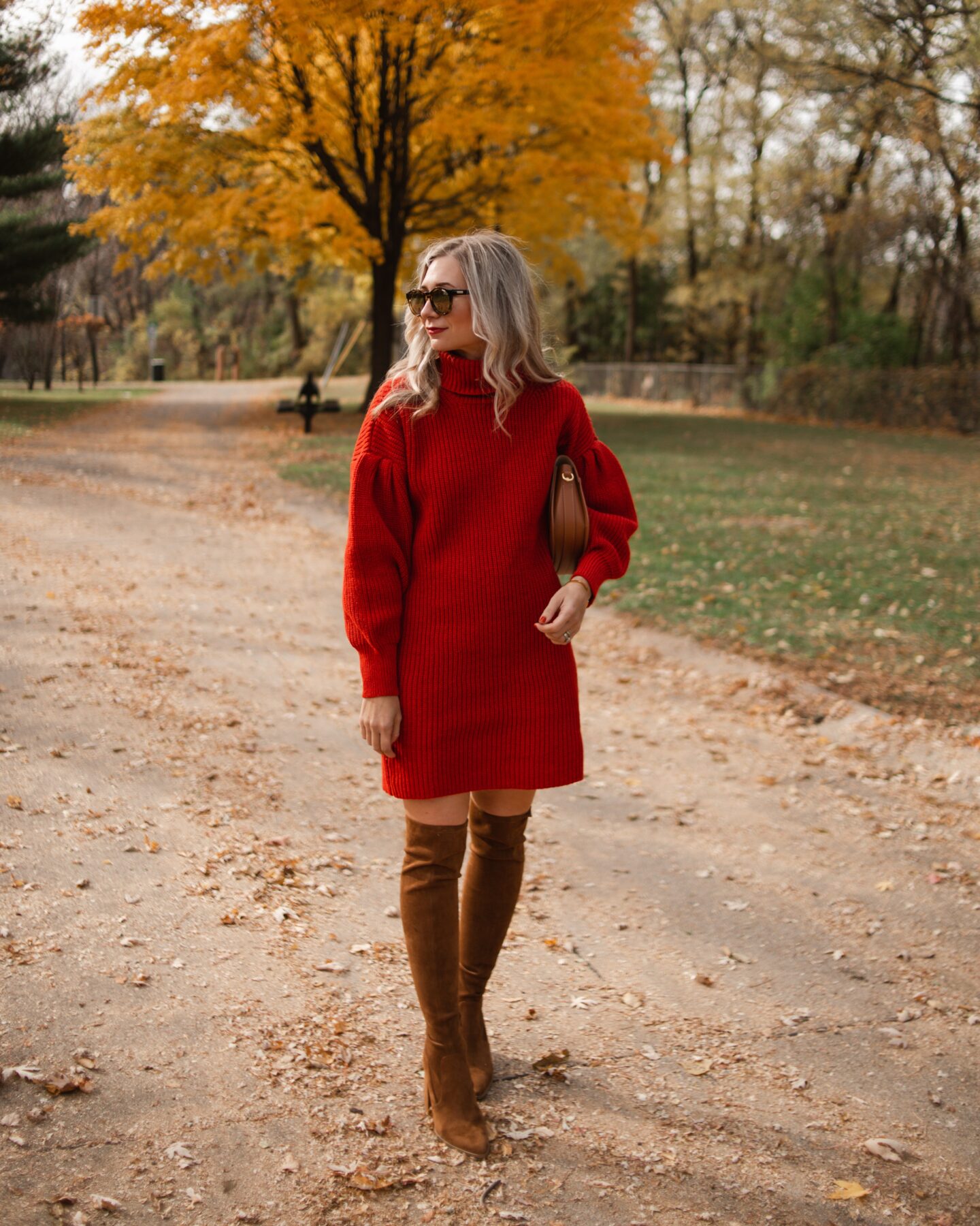 Karin Emily wears a red sweater dress from Free Assembly at Walmart and a pair of brown over the knee boots