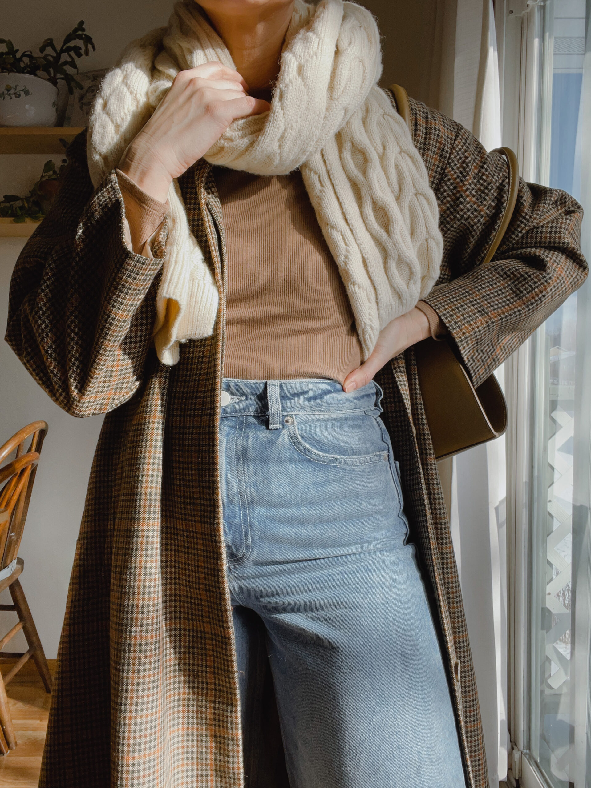 Karin Emily wears a toteme trench coat, madewell bodysuit, wide leg jeans, cableknit scarf,