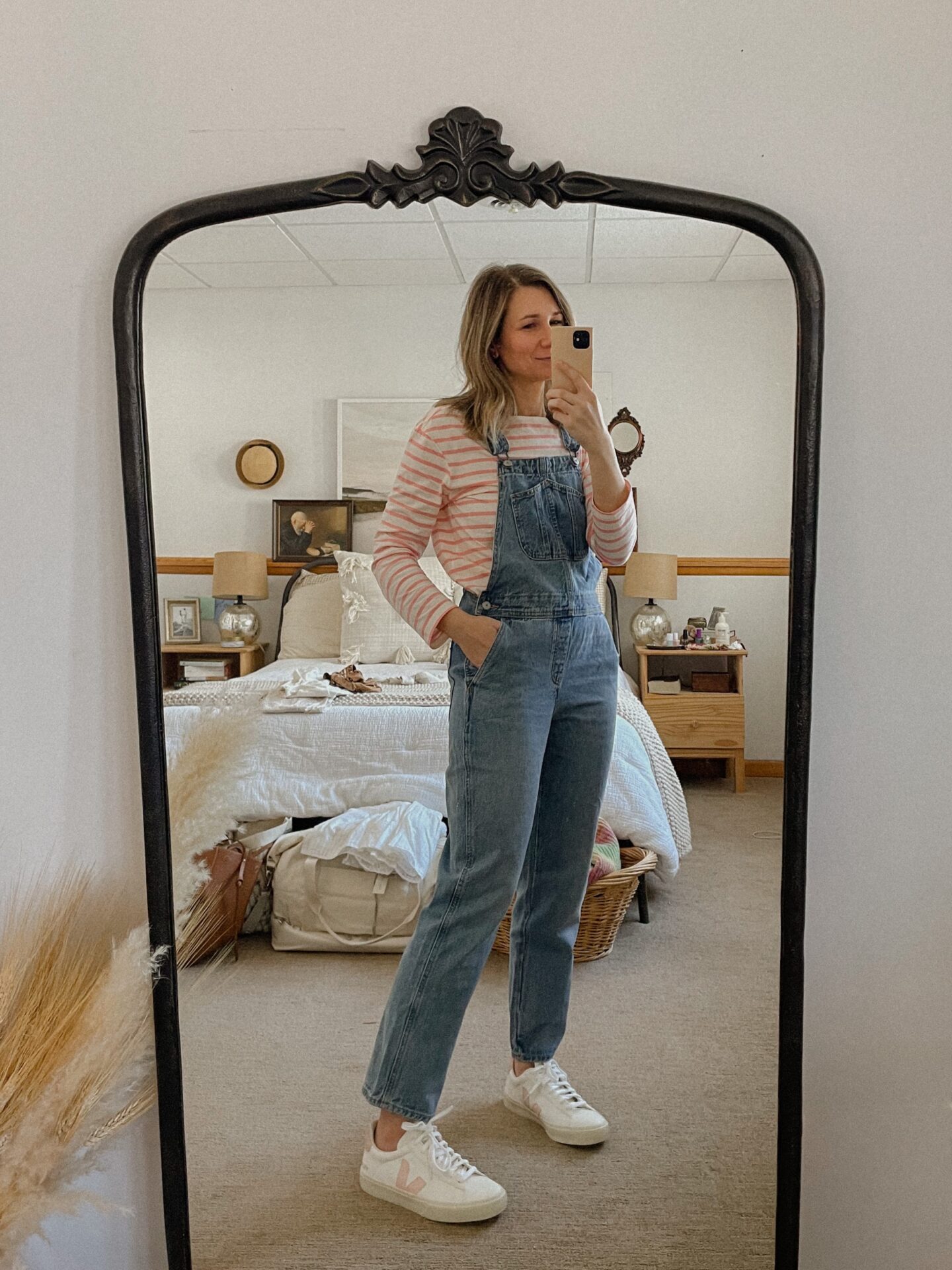 Karin Emily wears pink stripes and overalls with a pair of pink vejas