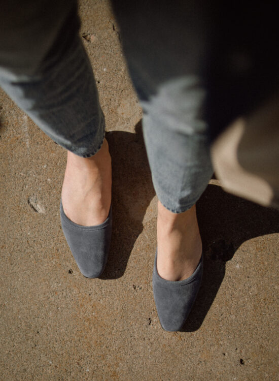 Karin Emily wears a blue suede pair of mules