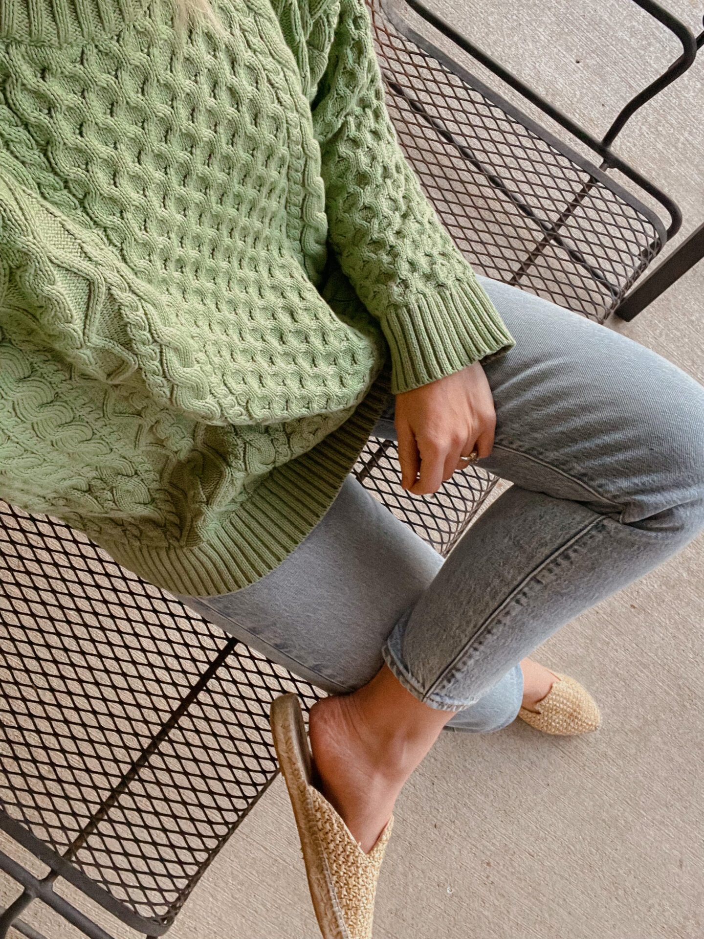 Karin Emily wears green for luck - a green sweater, light wash levi jeans, woven mules