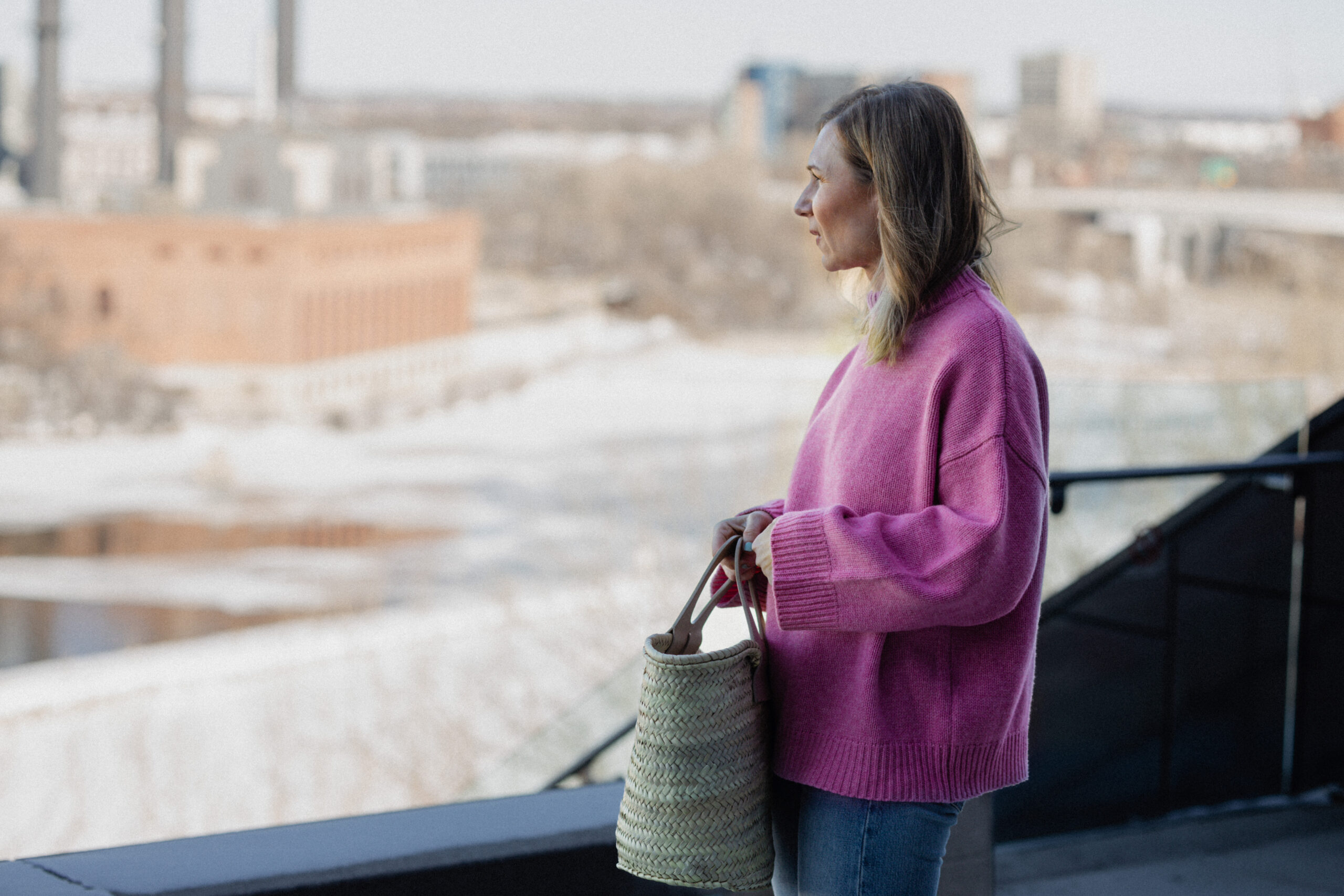 Karin Emily wears a pink sweater, blue jeans, and a pair of pink Mary Jane's