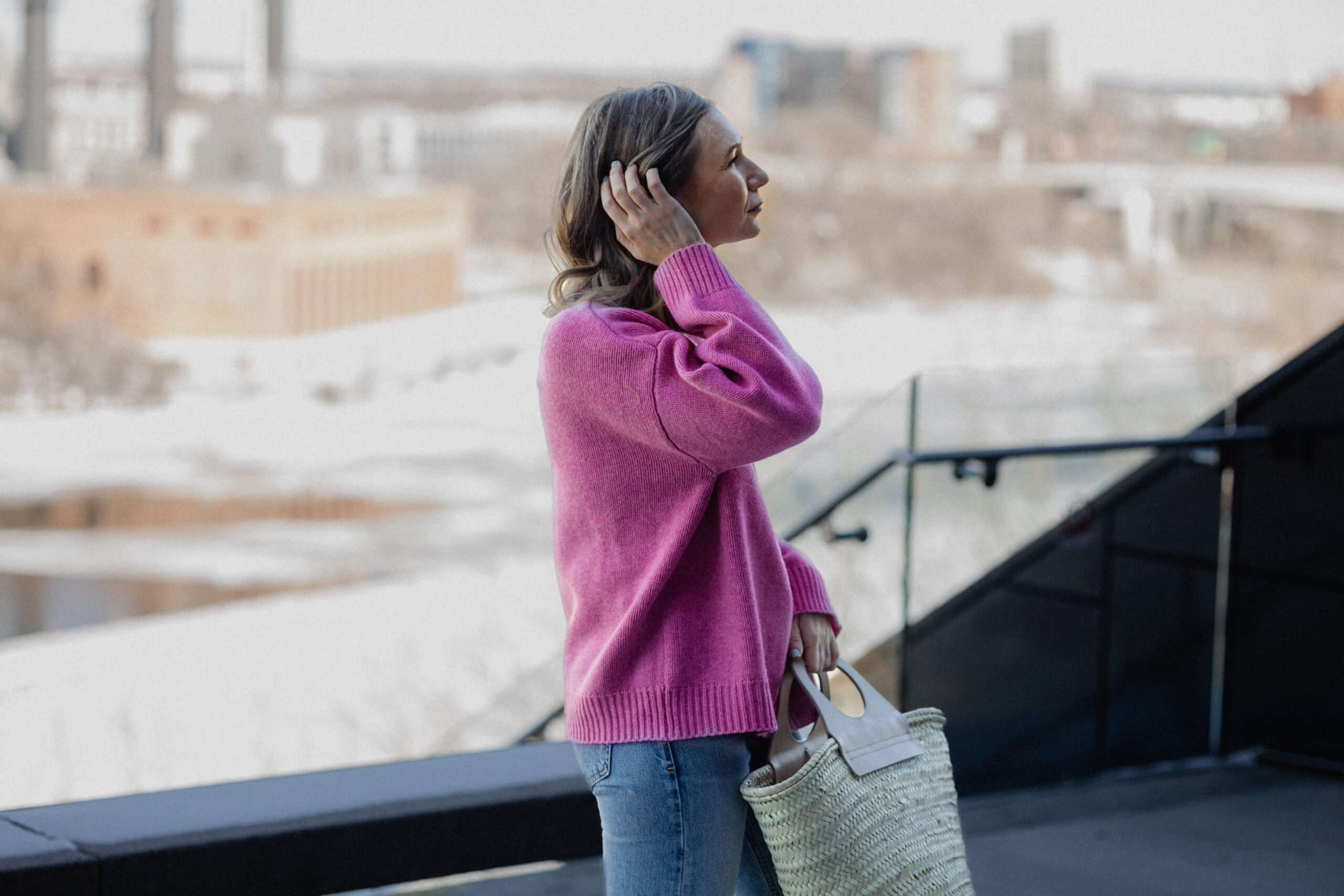 Karin Emily wears a pink sweater, blue jeans, and a pair of pink Mary Jane's