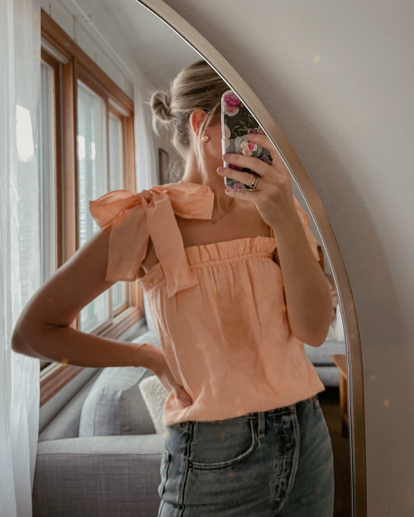 Karin Emily wears a linen coral tank top for spring