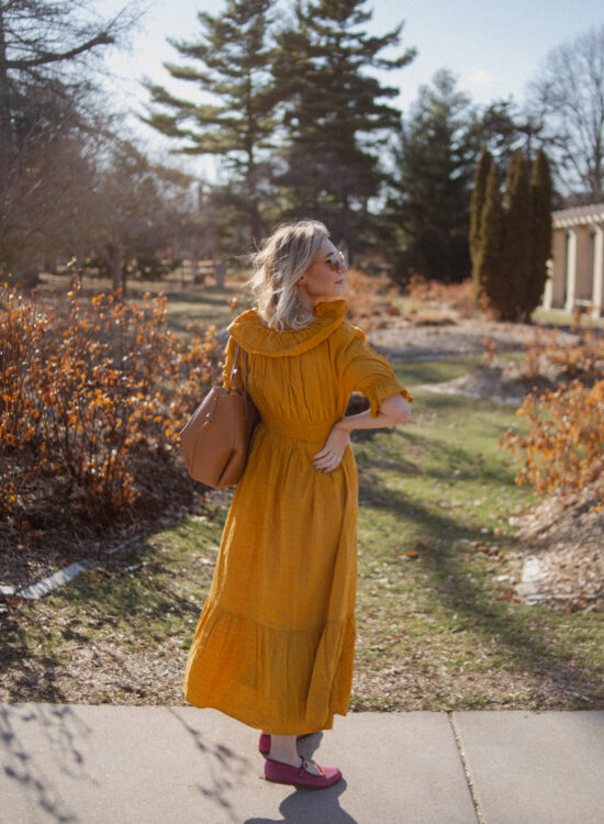 Karin Emily shares her favorites shoes for spring and wears a goldenrod yellow dress with a brown tote bag from Polene and pink mary jane flats