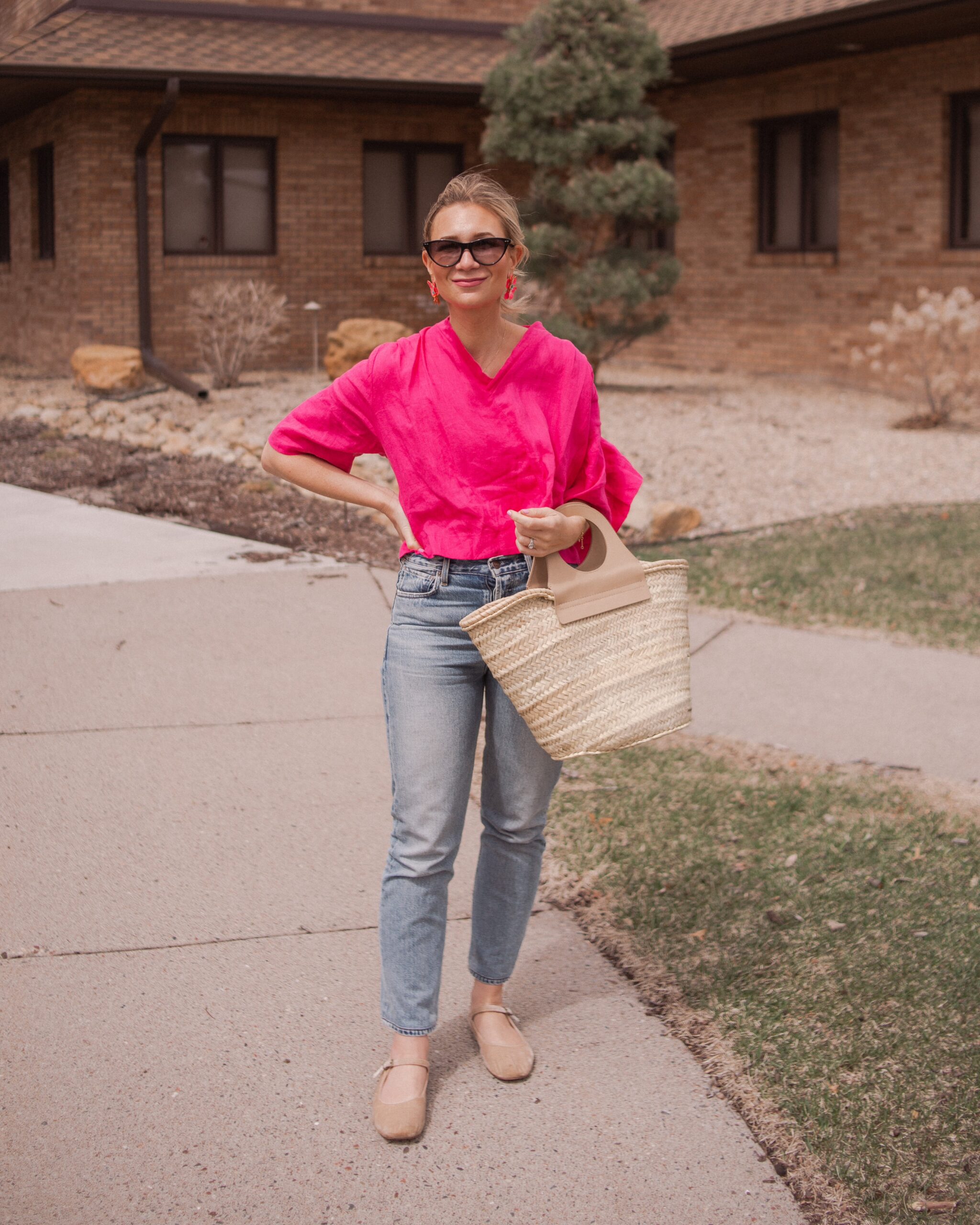 Karin Emily wears a fuchsia linen top from aliya wanek, citizens of humanity charlotte jeans, doen mary jane flats, a hereu basket bag, hand painted flower earrings from the Pink Reef and Isabel Marant Sunglasses 