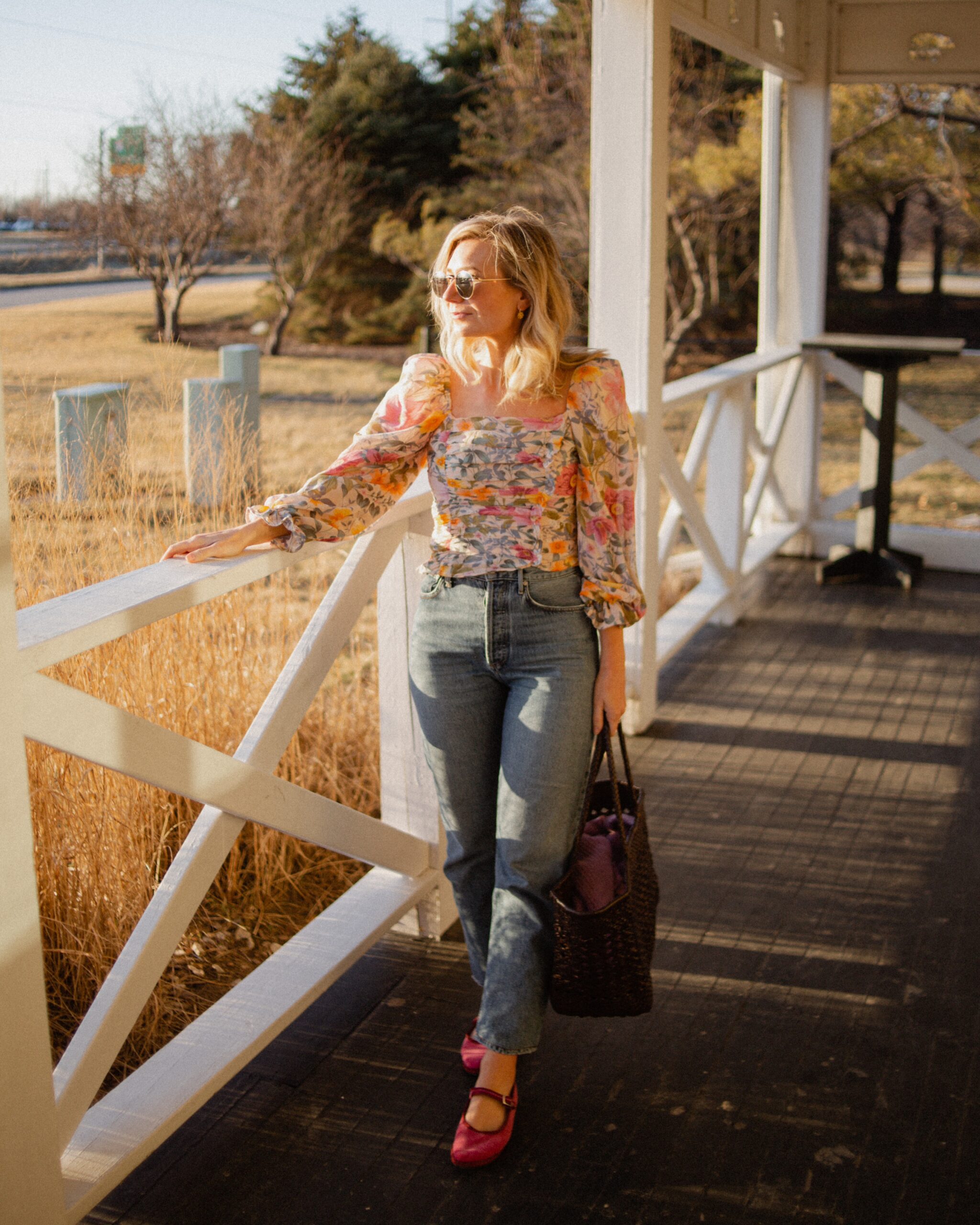 Karin Emily wears a floral puff sleeve top from the Shopbop Style Event with Citizens of Humanity Charlotte Jeans, Pink Mary Jane Flats, and a Dragon Diffusion Bag