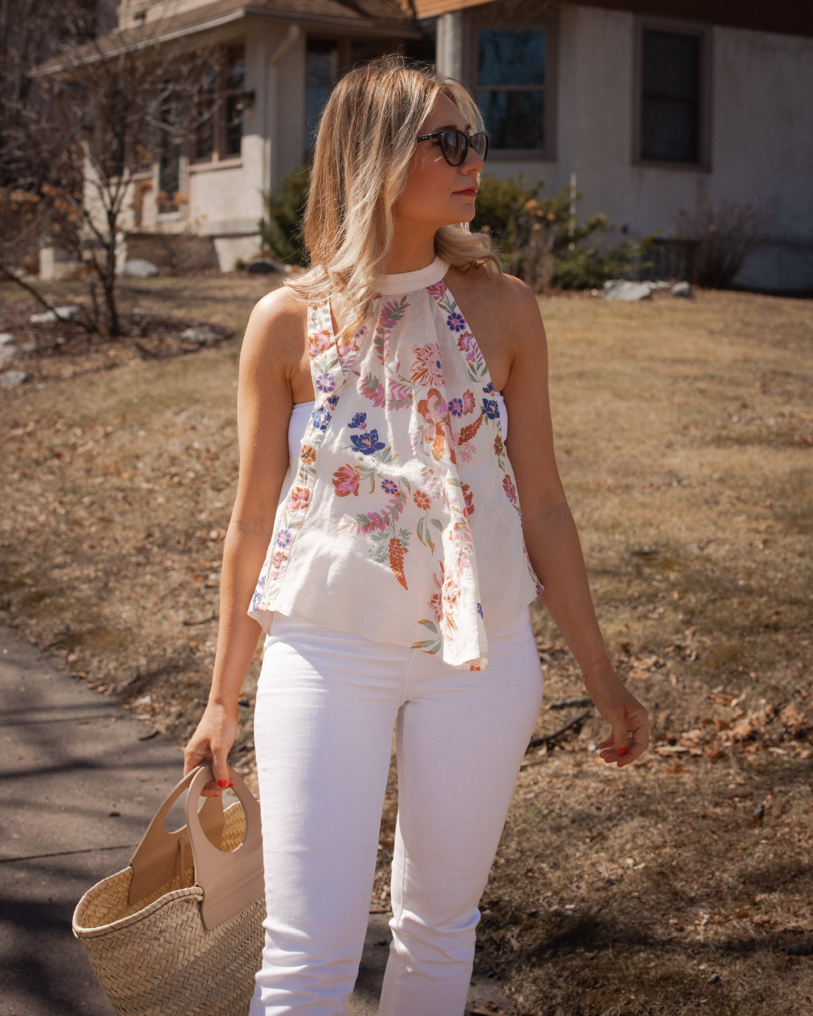 Karin Emily shares a mother's day brunch look with a floral halter top, white crop top, white jeans from Mother, and Isabel Marant Sunglasses