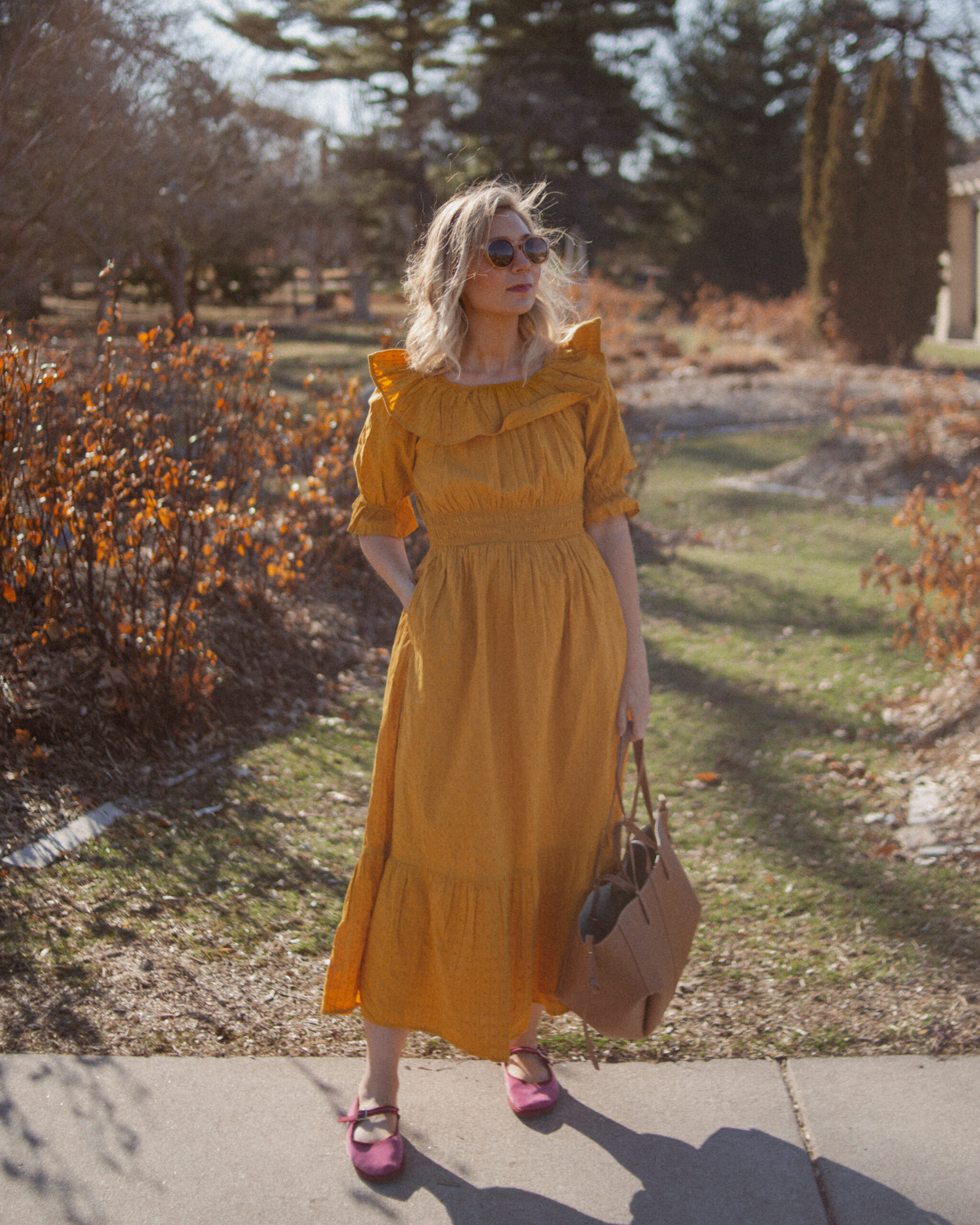 Karin Emily shares her favorites shoes for spring and wears a goldenrod yellow dress with a brown tote bag from Polene and pink mary jane flats