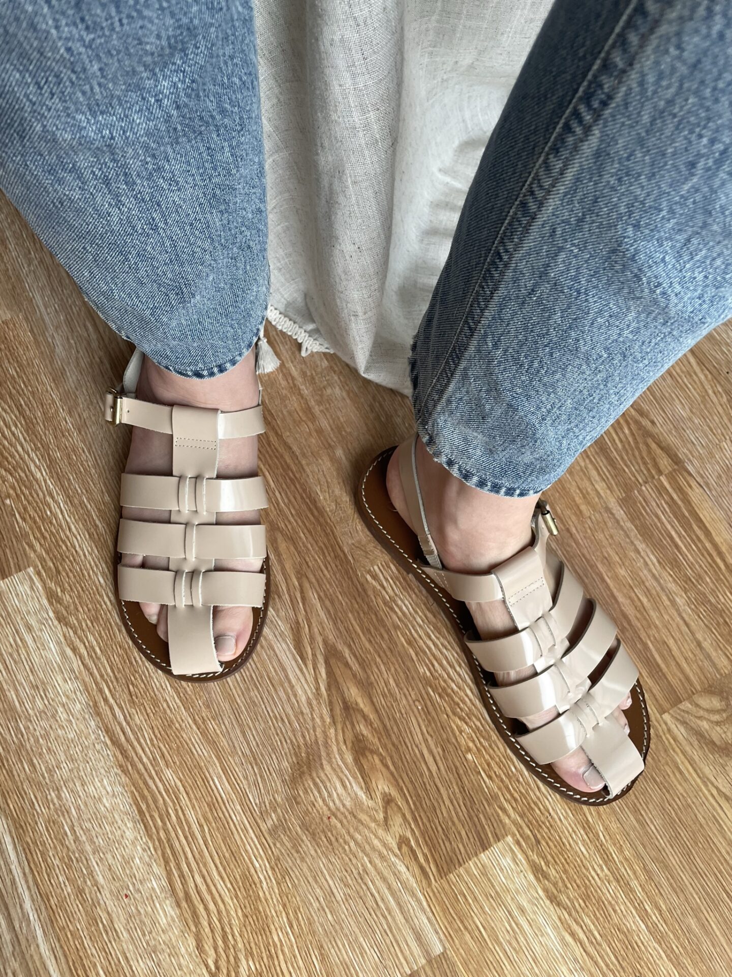 Karin Emily wears a pair of pale pink fisherman sandals from J. Crew