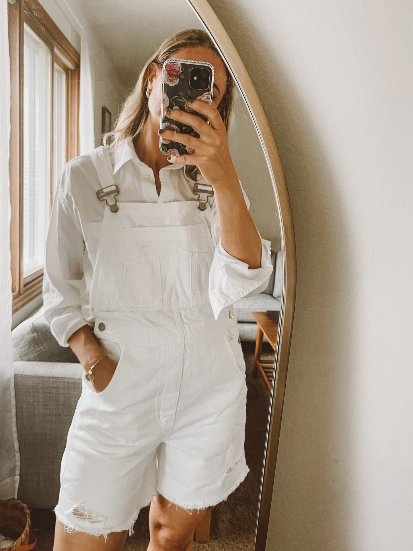 Karin Emily wears a white button down and white overall shorts from the Gap