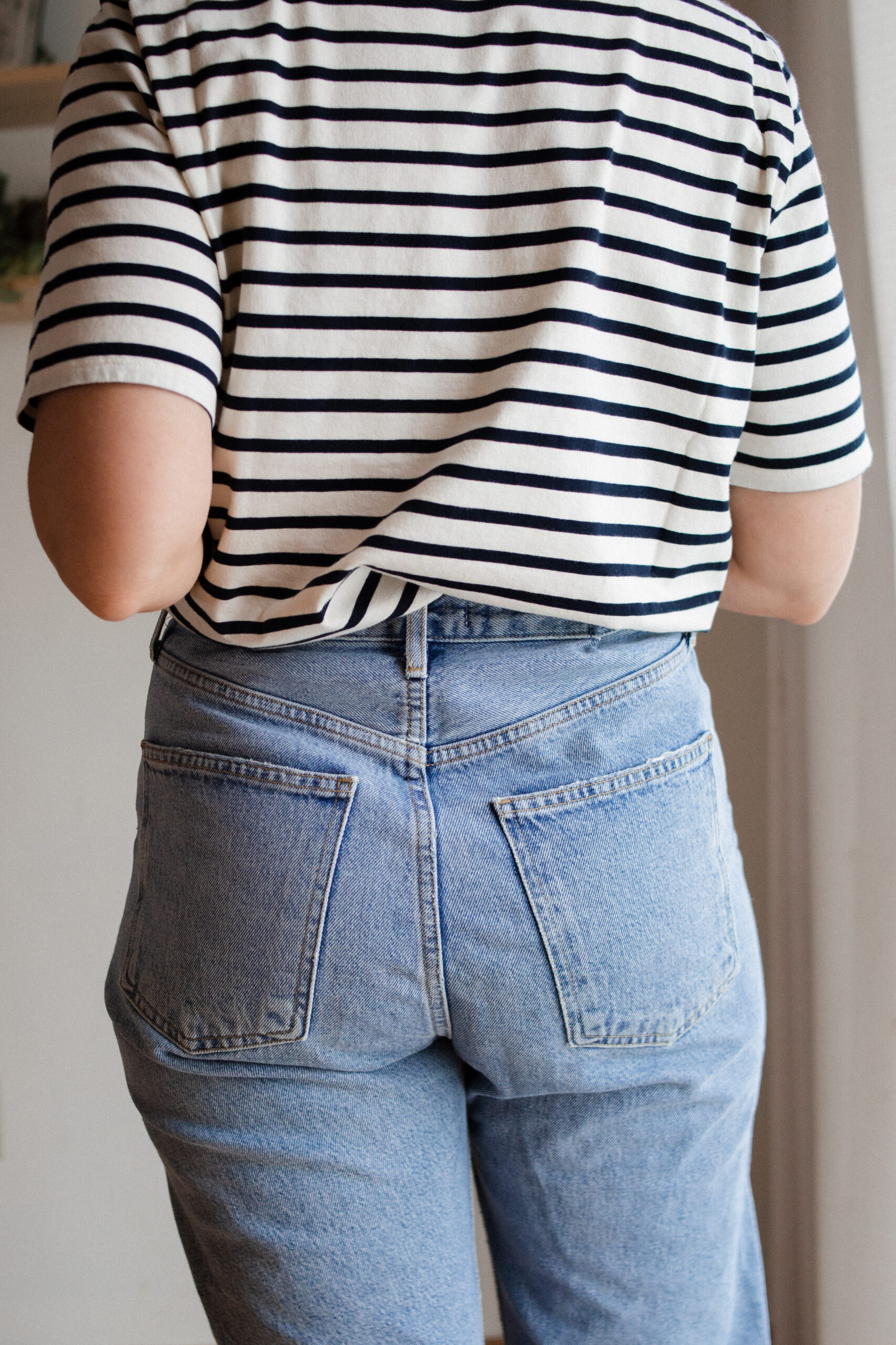 Karin Emily wears a pair of AGOLDE 90's straight jeans with a striped tee and brown sandals for her AGOLDE denim guide