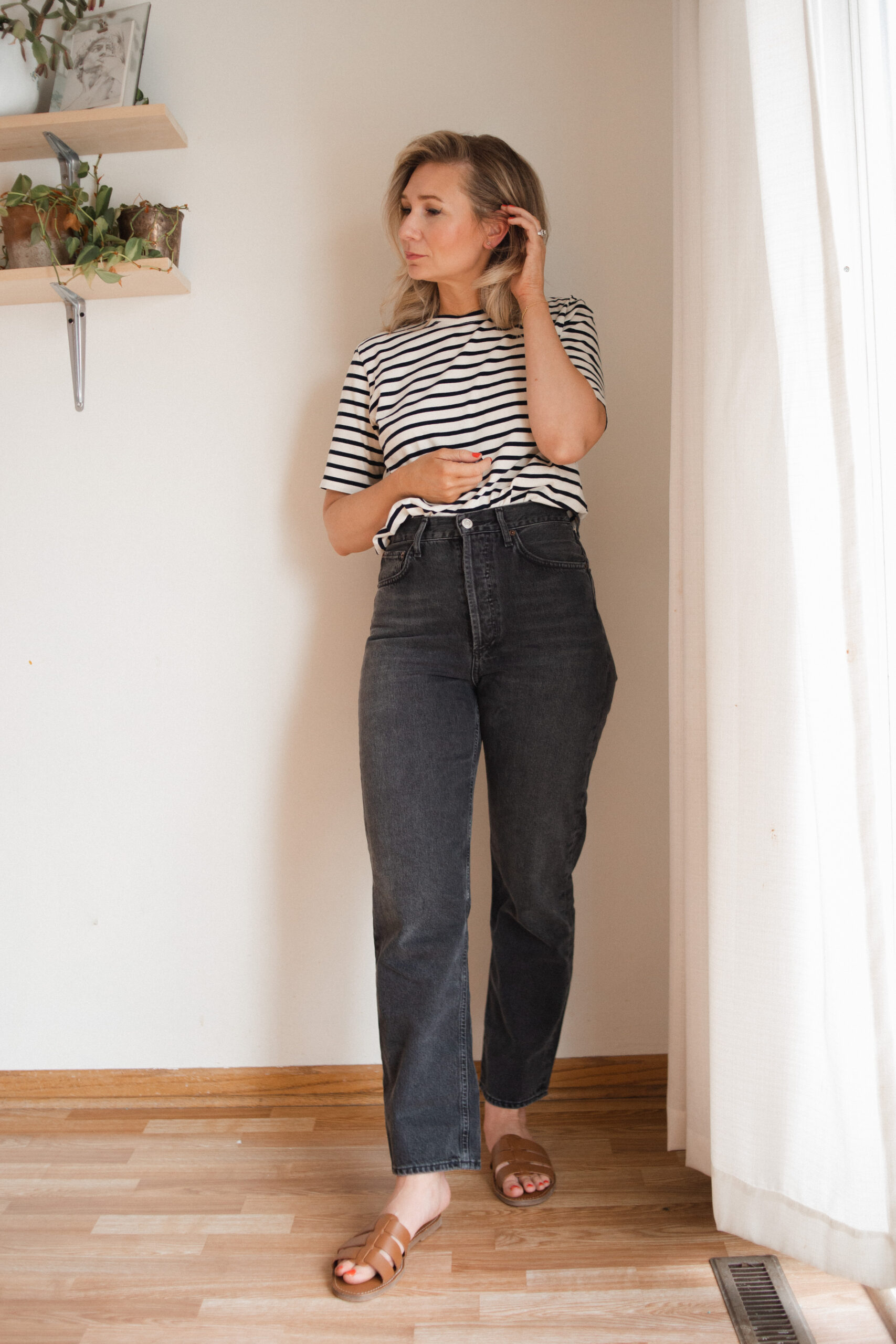 Karin Emily wears a pair of AGOLDE 90's midrise jeans with a striped tee and brown sandals for her AGOLDE denim guide