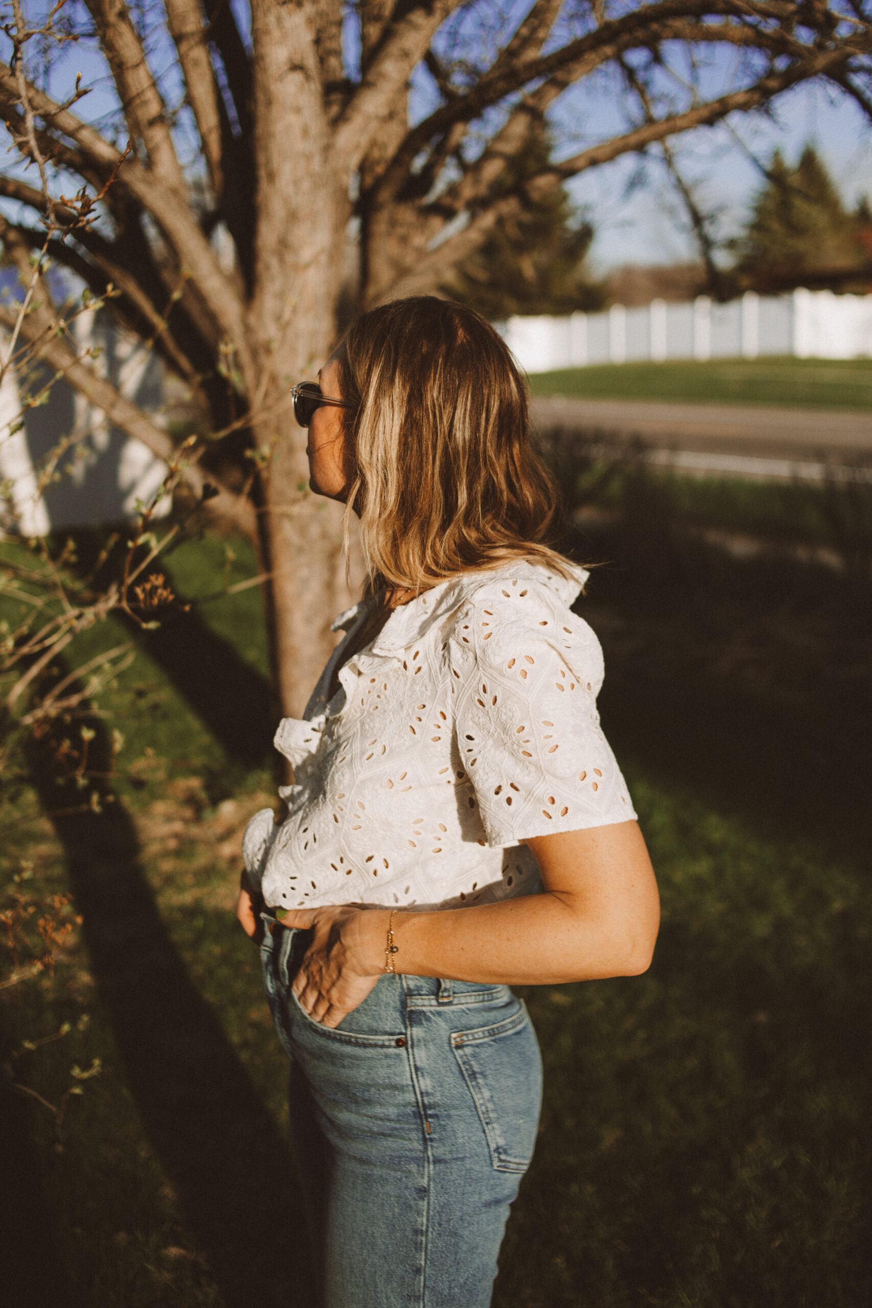 Karin Emily wears a white sezane top and wide leg Madewell jeans