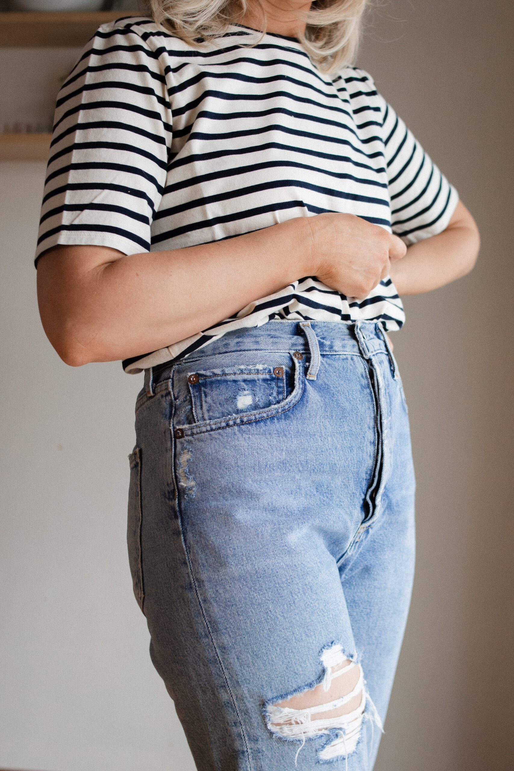 Karin Emily wears a pair of AGOLDE 90's straight jeans with a striped tee and brown sandals for her AGOLDE denim guide