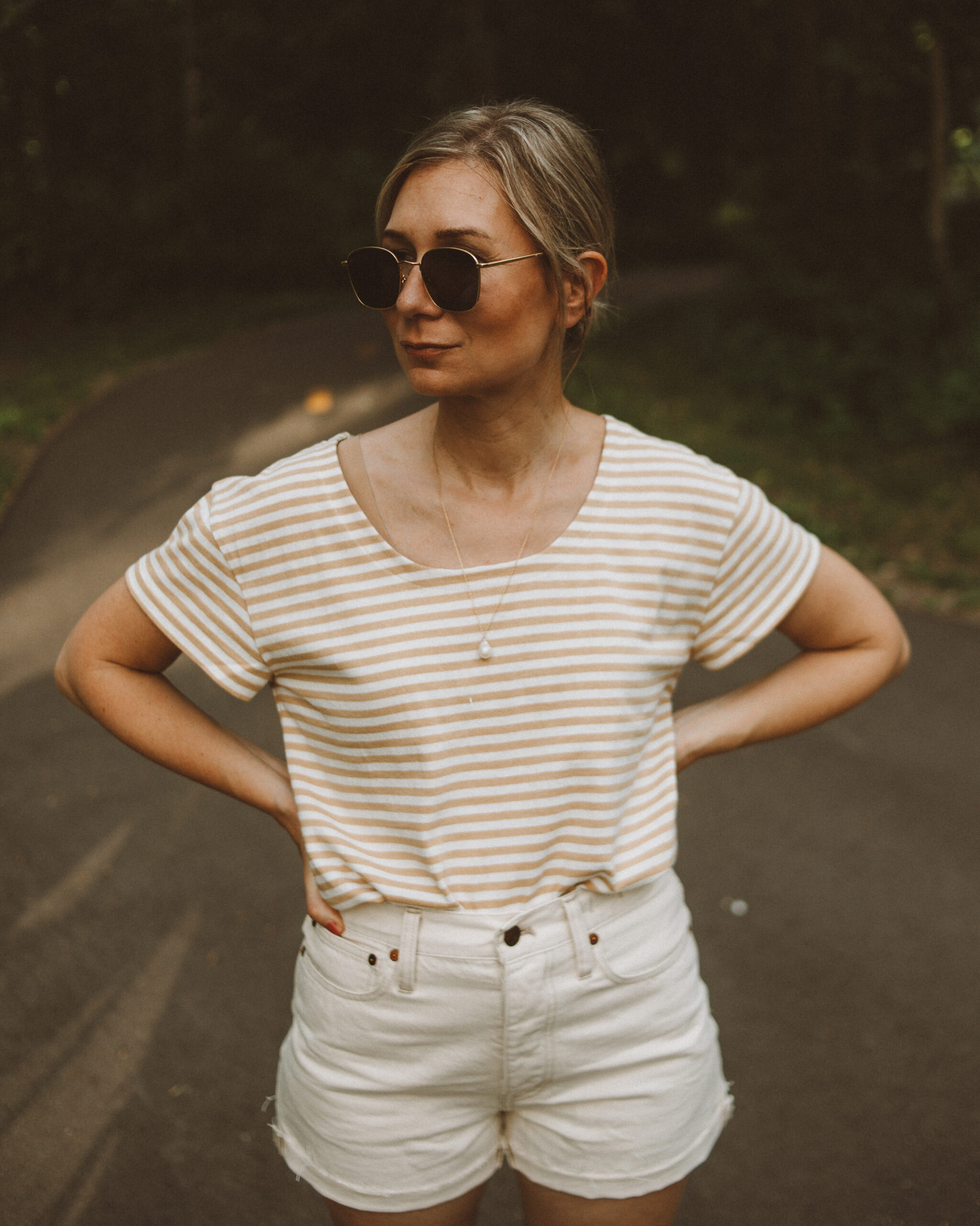 Karin Emily wears a striped tee and cream jean shorts