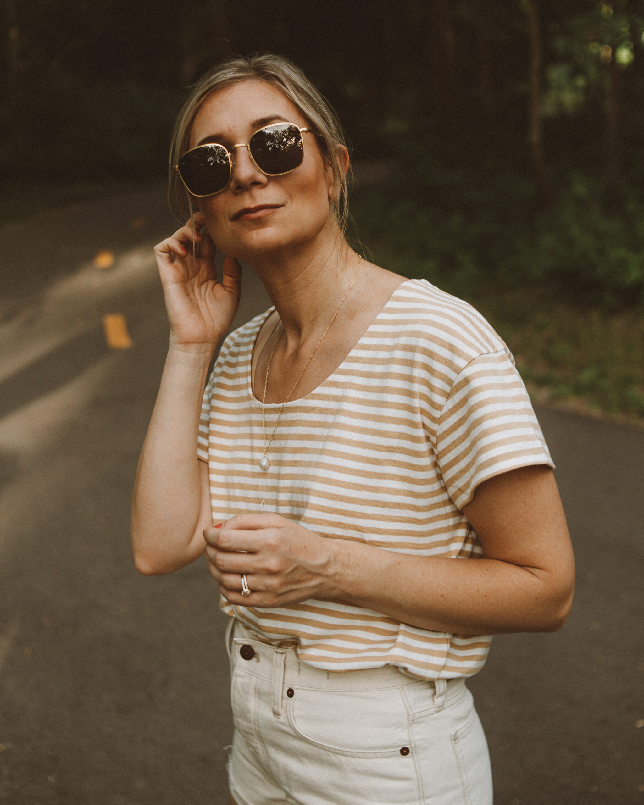 Karin Emily wears a striped tee and cream jean shorts