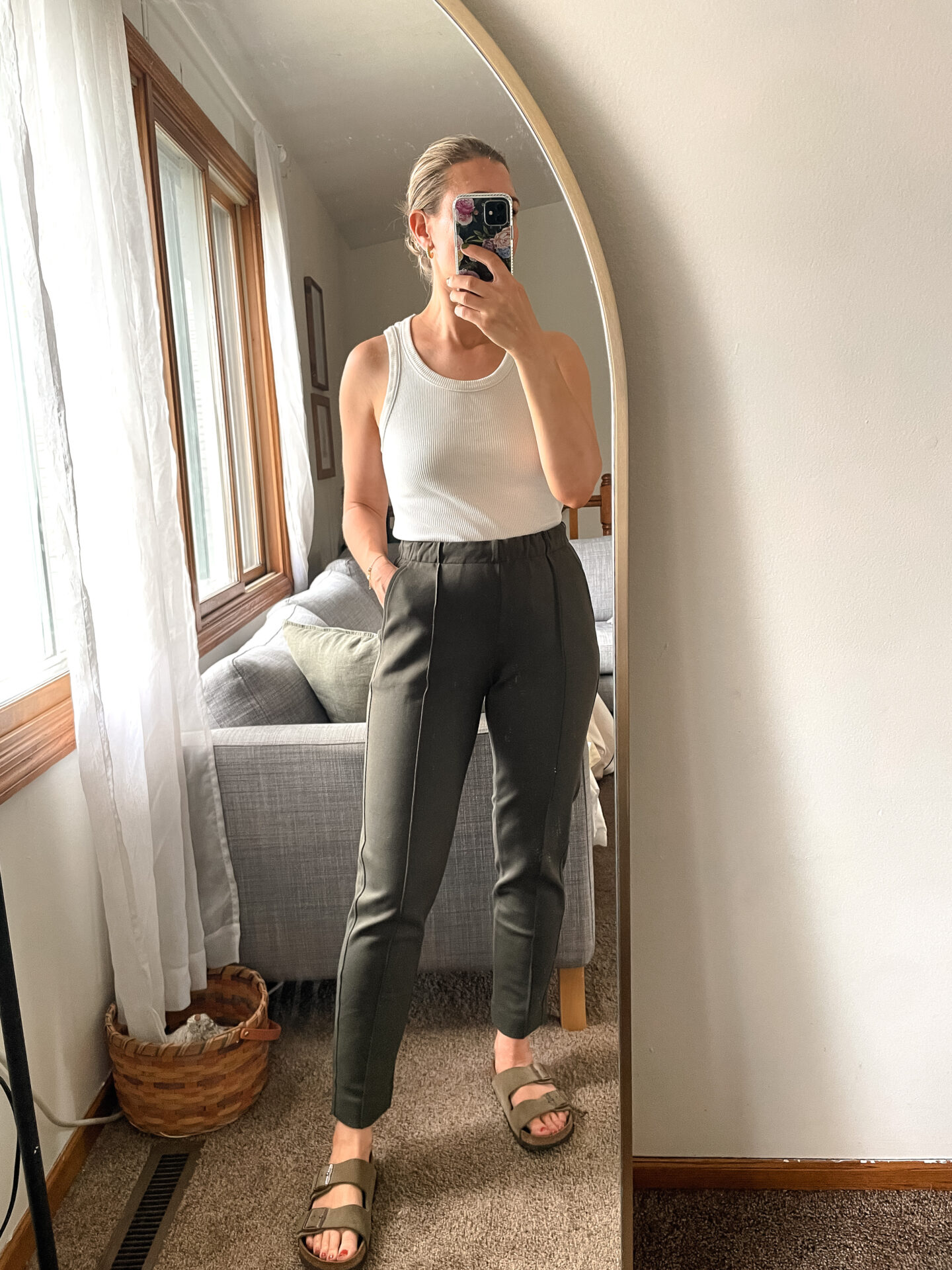 Karin Emily wears a pair of Everlane Pants with a white tank and birkenstock arizona sandals