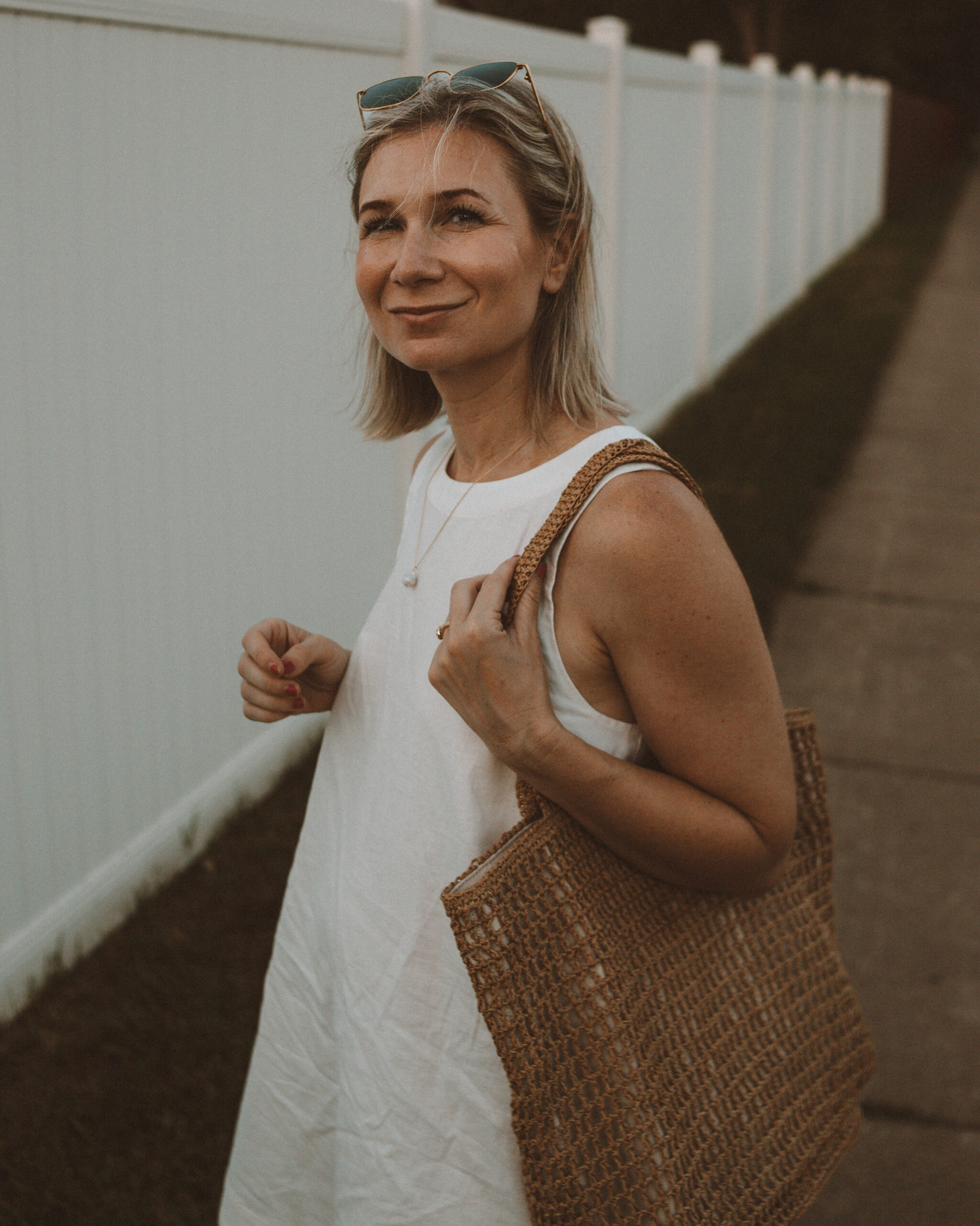 Karin Emily wears one of her favorite hot weather staples - a little white linen dress