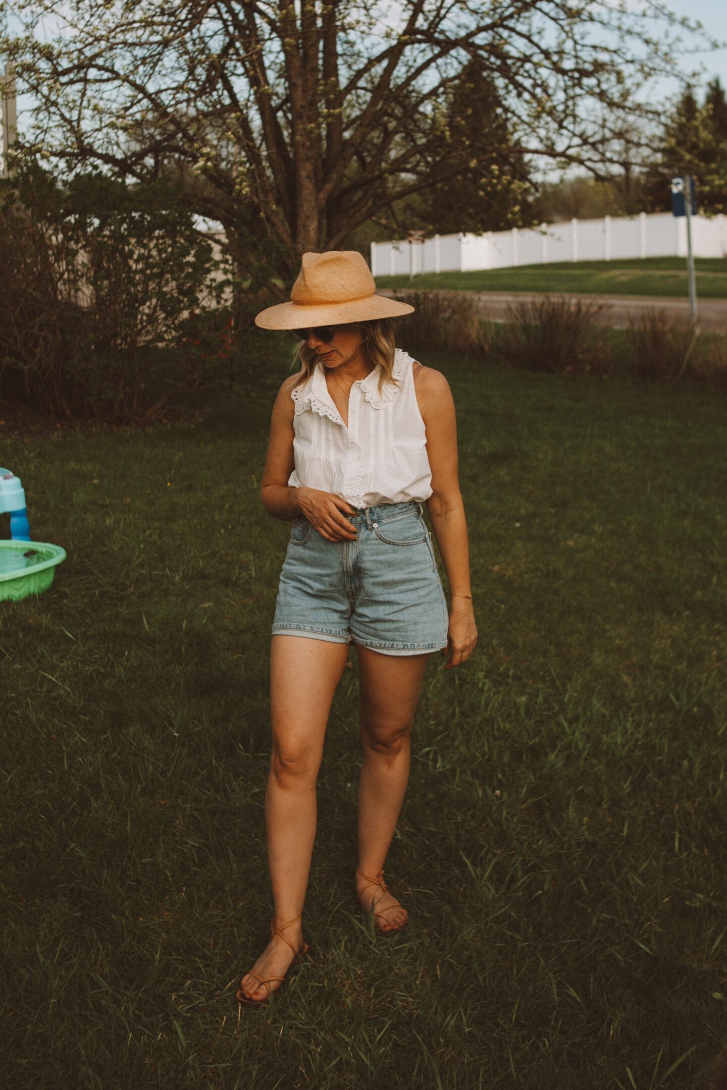 Karin Emily wears her favorite denim shorts with a white button down.