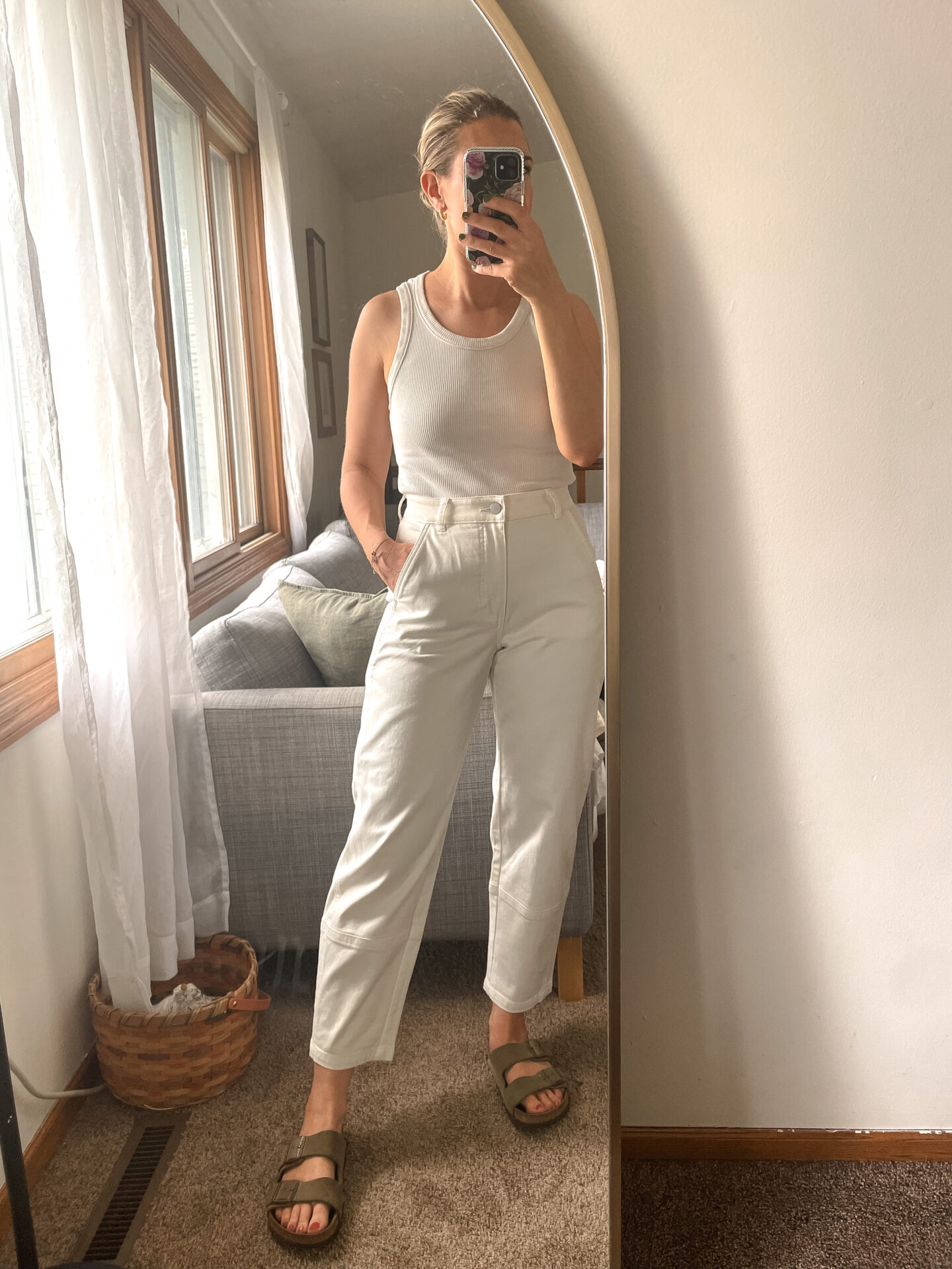 Karin Emily wears a pair of Everlane Pants with a white tank and birkenstock arizona sandals