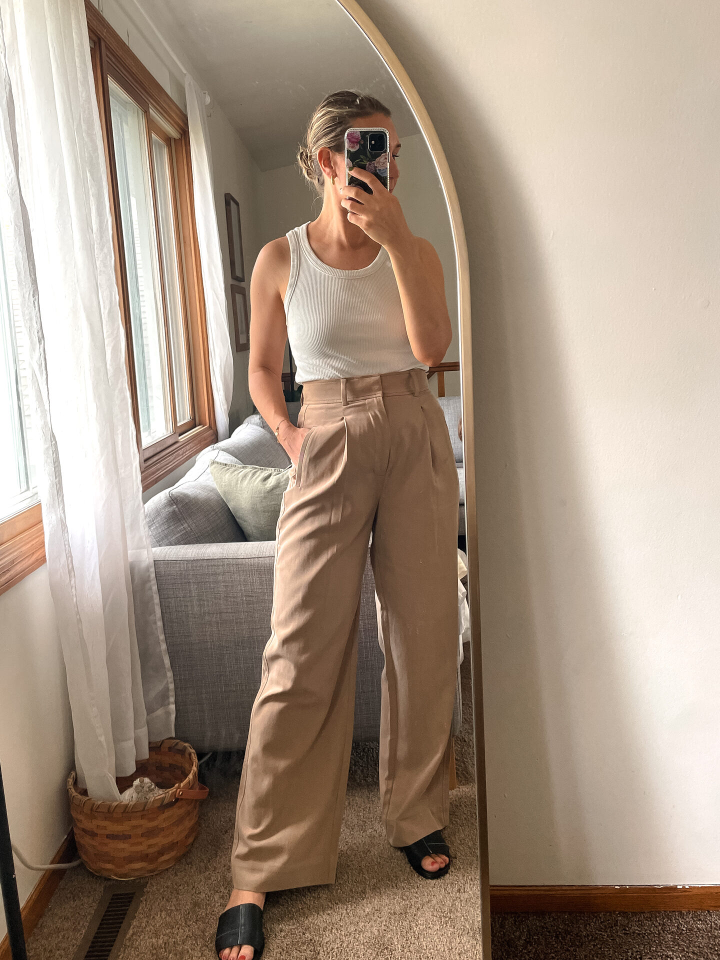 Karin Emily wears a pair of Everlane Pants with a white tank and birkenstock arizona sandals