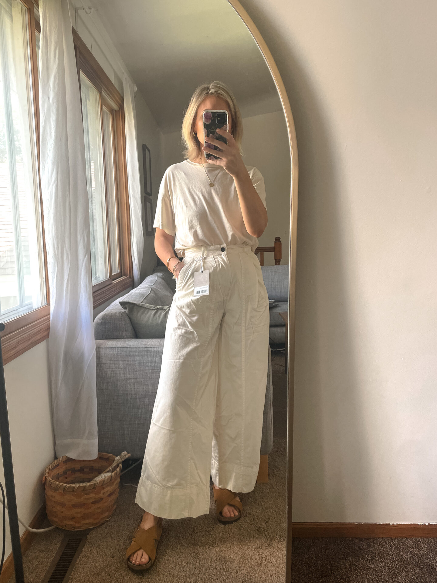 Karin Emily wears a pair of Everlane Pants with a white tank and birkenstock arizona sandals