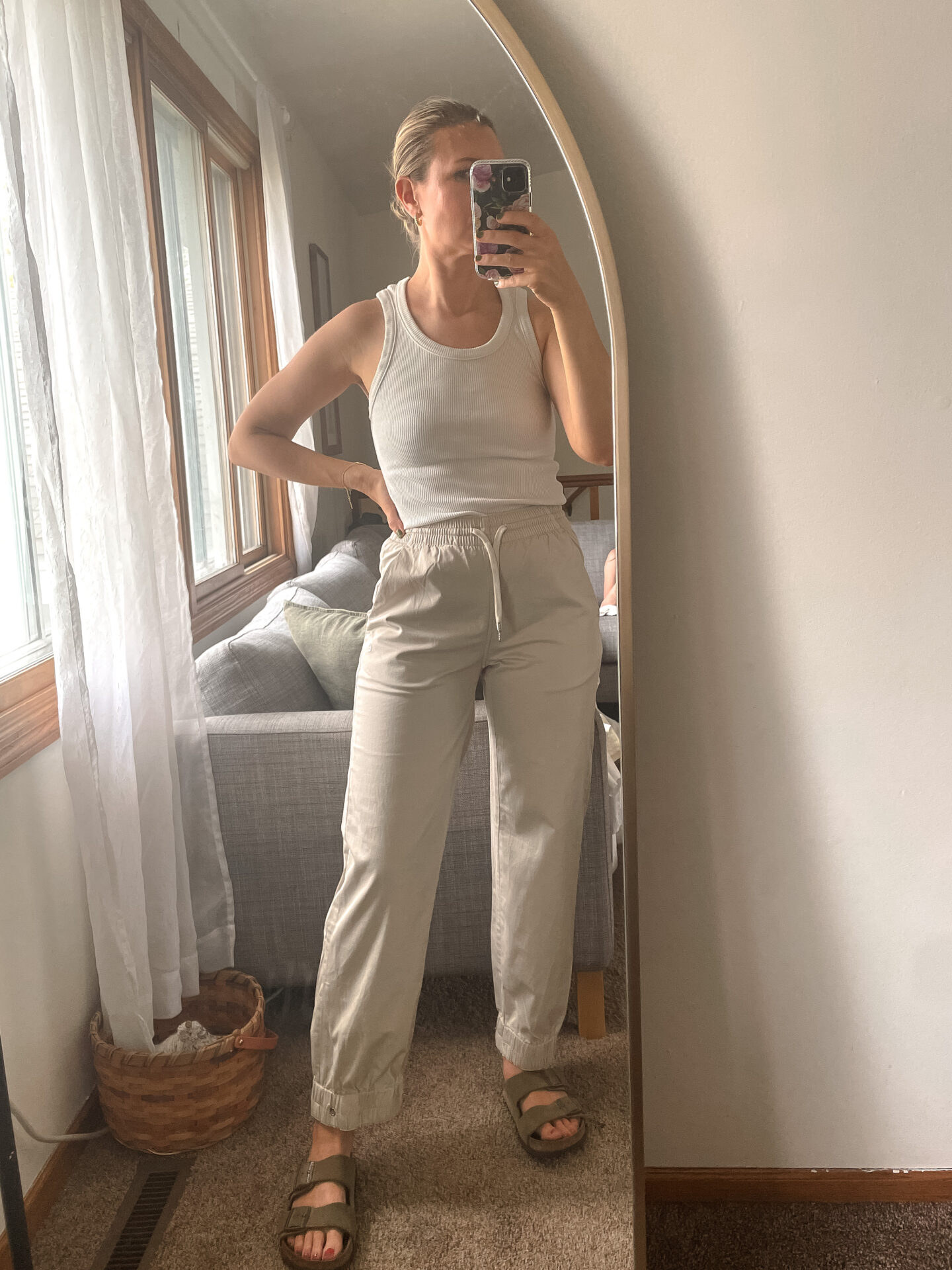 Karin Emily wears a pair of Everlane Pants with a white tank and birkenstock arizona sandals