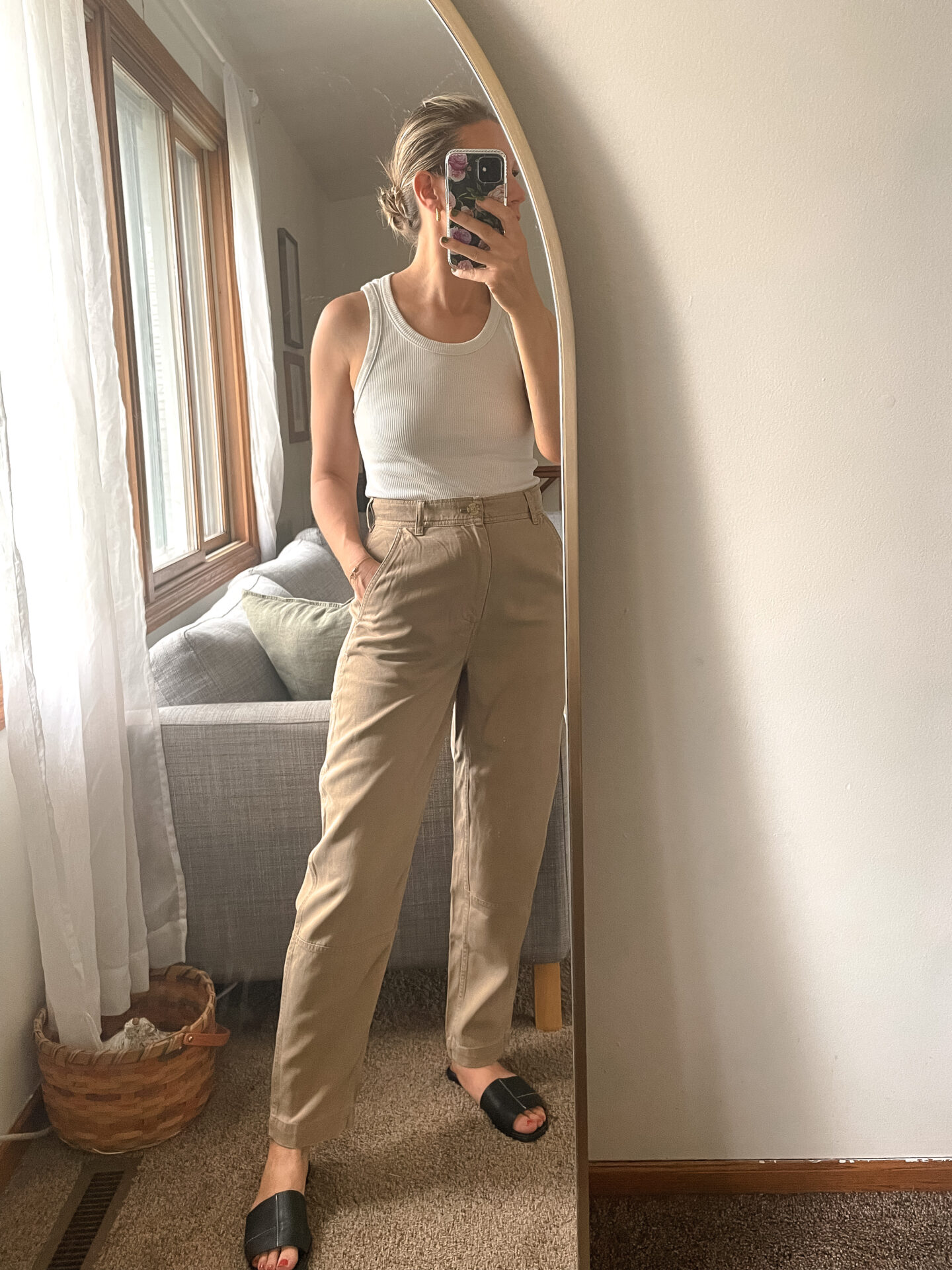 Karin Emily wears a pair of Everlane Pants with a white tank and birkenstock arizona sandals